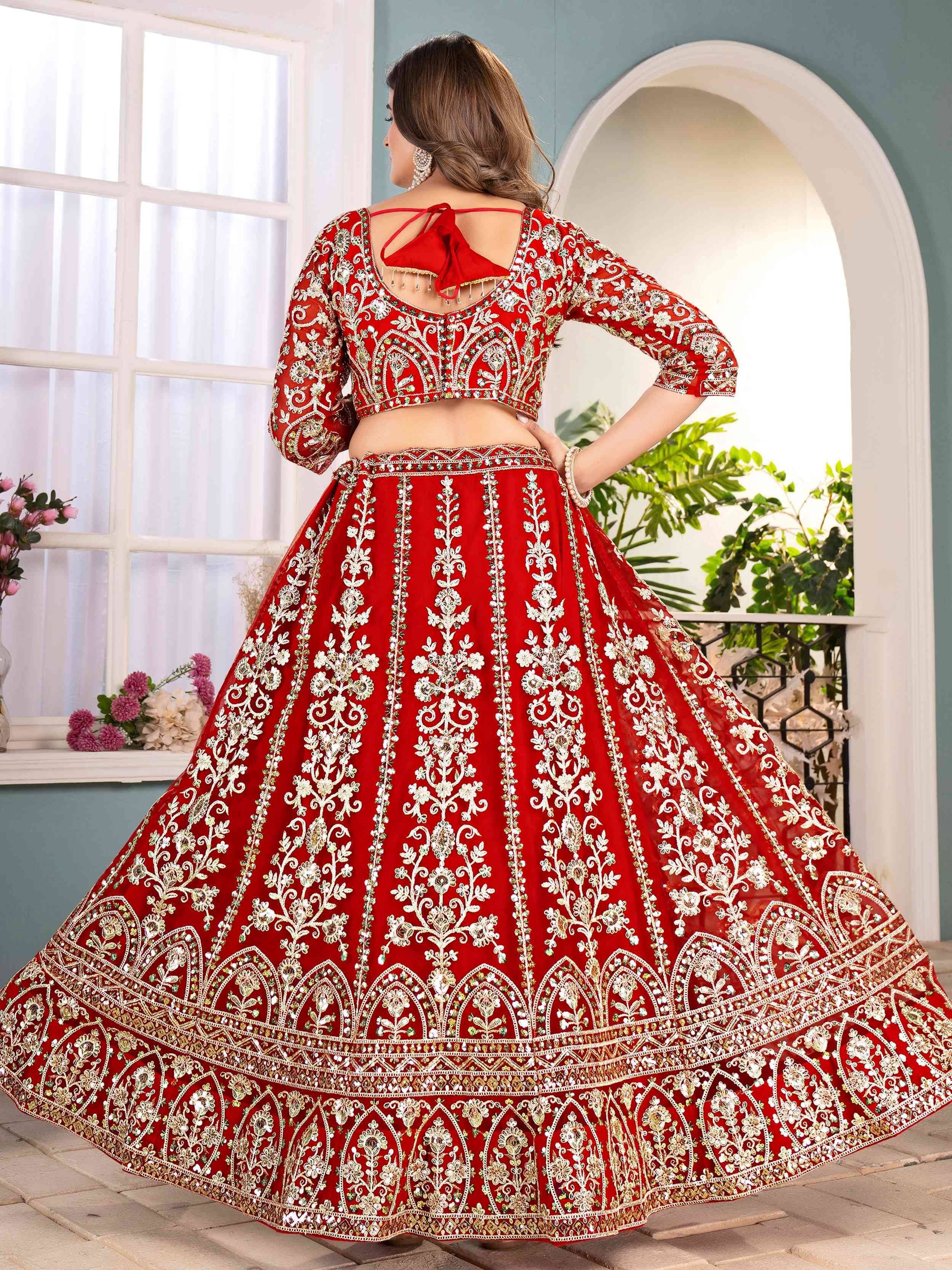 Red embroidered lehenga choli with floral gold detailing, perfect for Indian weddings and festive occasions.