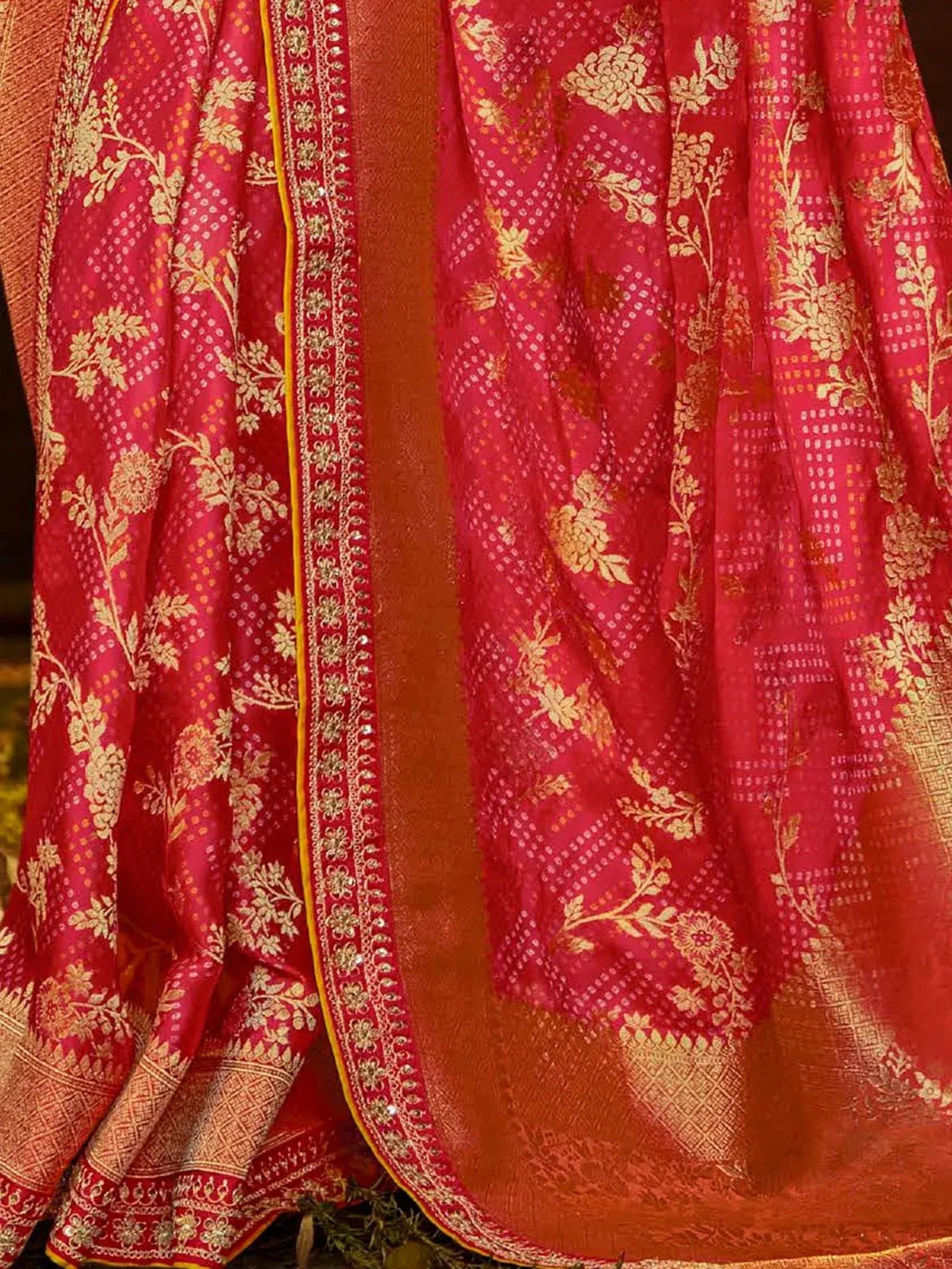 Red and gold floral embroidered Indian saree with intricate border detailing
