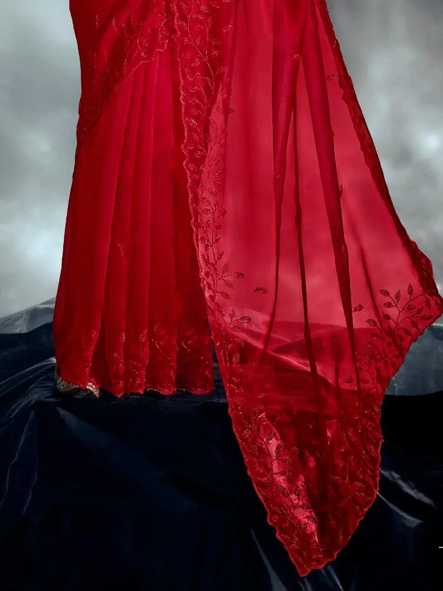 Red embroidered ethnic gown with sheer dupatta, perfect for Indian weddings and festive occasions.