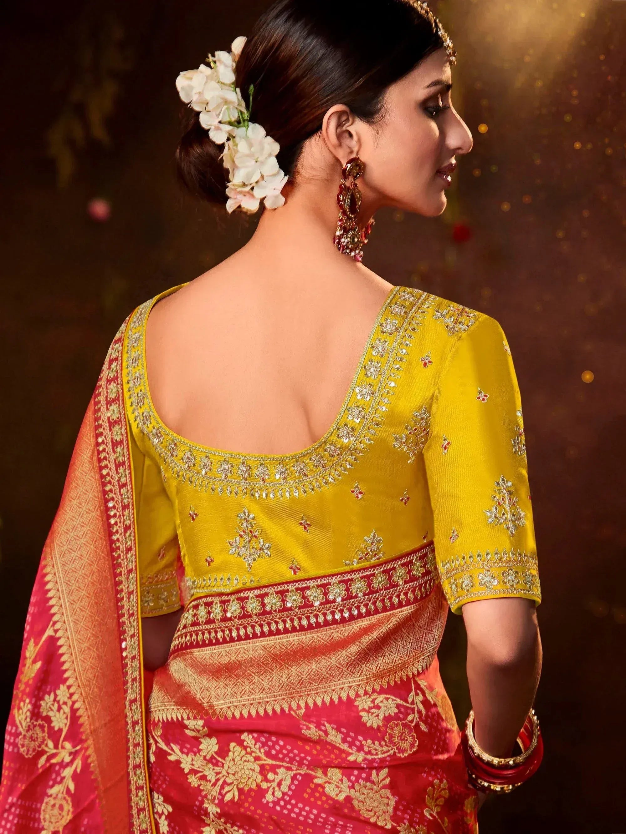 Yellow embroidered blouse with red gold saree, floral hair accessory, traditional Indian ethnic wear