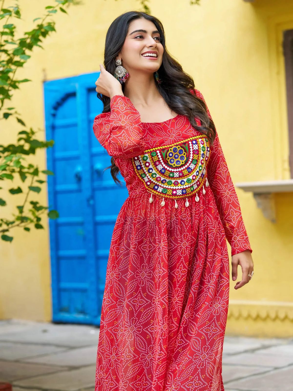 Red ethnic gown with mirror work and bandhani print, perfect for Indian festivals and occasions