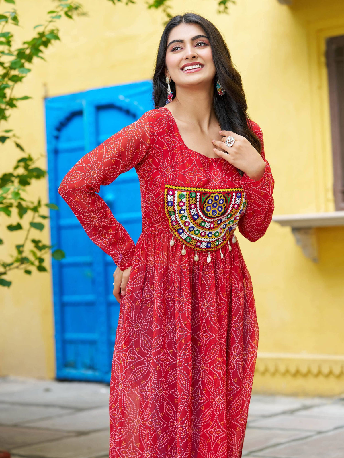 Red ethnic gown with mirror work and embroidery, perfect for festive occasions and Indian celebrations.