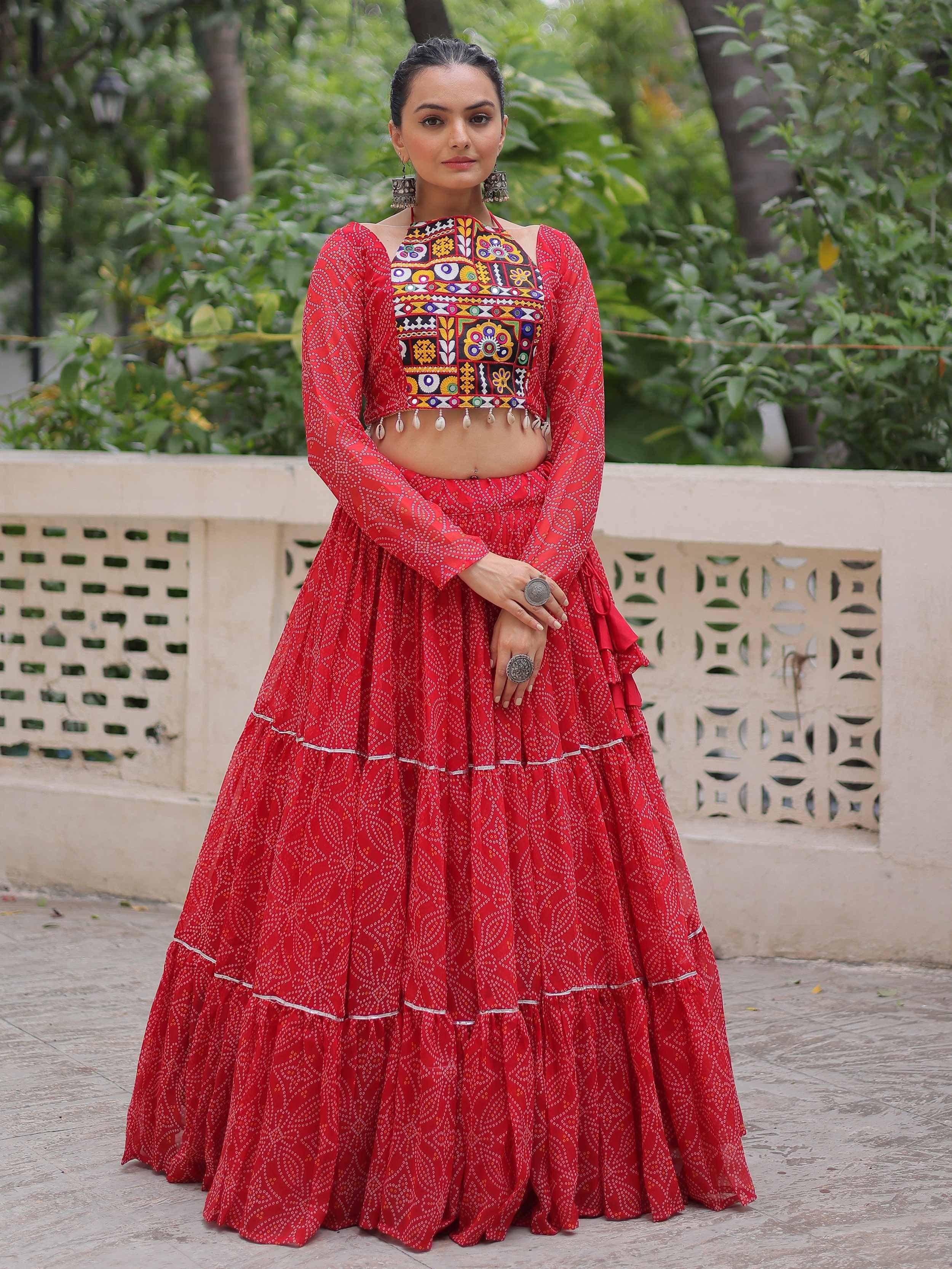 Red printed lehenga choli with colorful embroidery and mirror work, perfect for ethnic occasions
