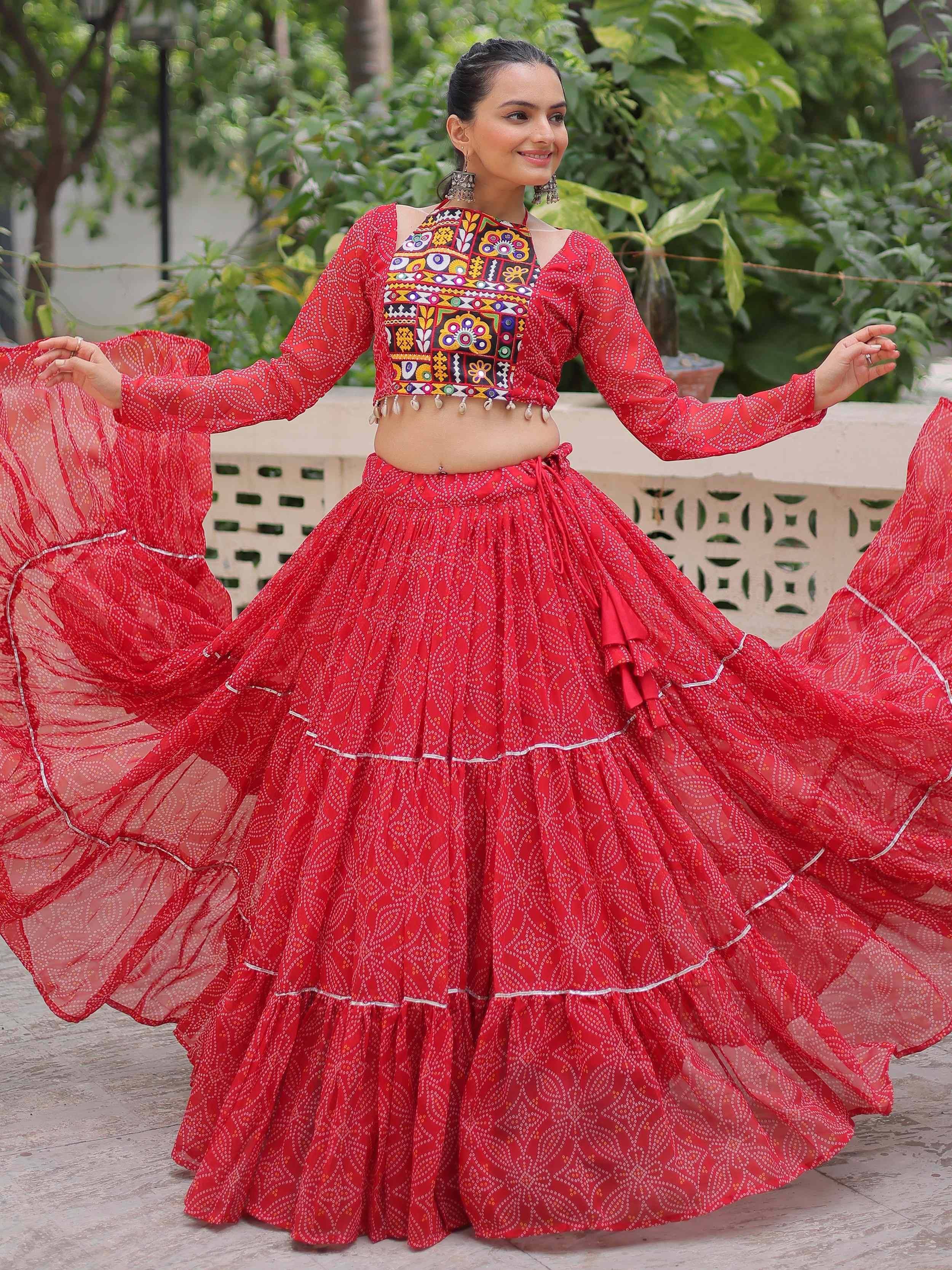 Red ethnic lehenga choli with mirror work and flared skirt, perfect for Indian festivals and weddings