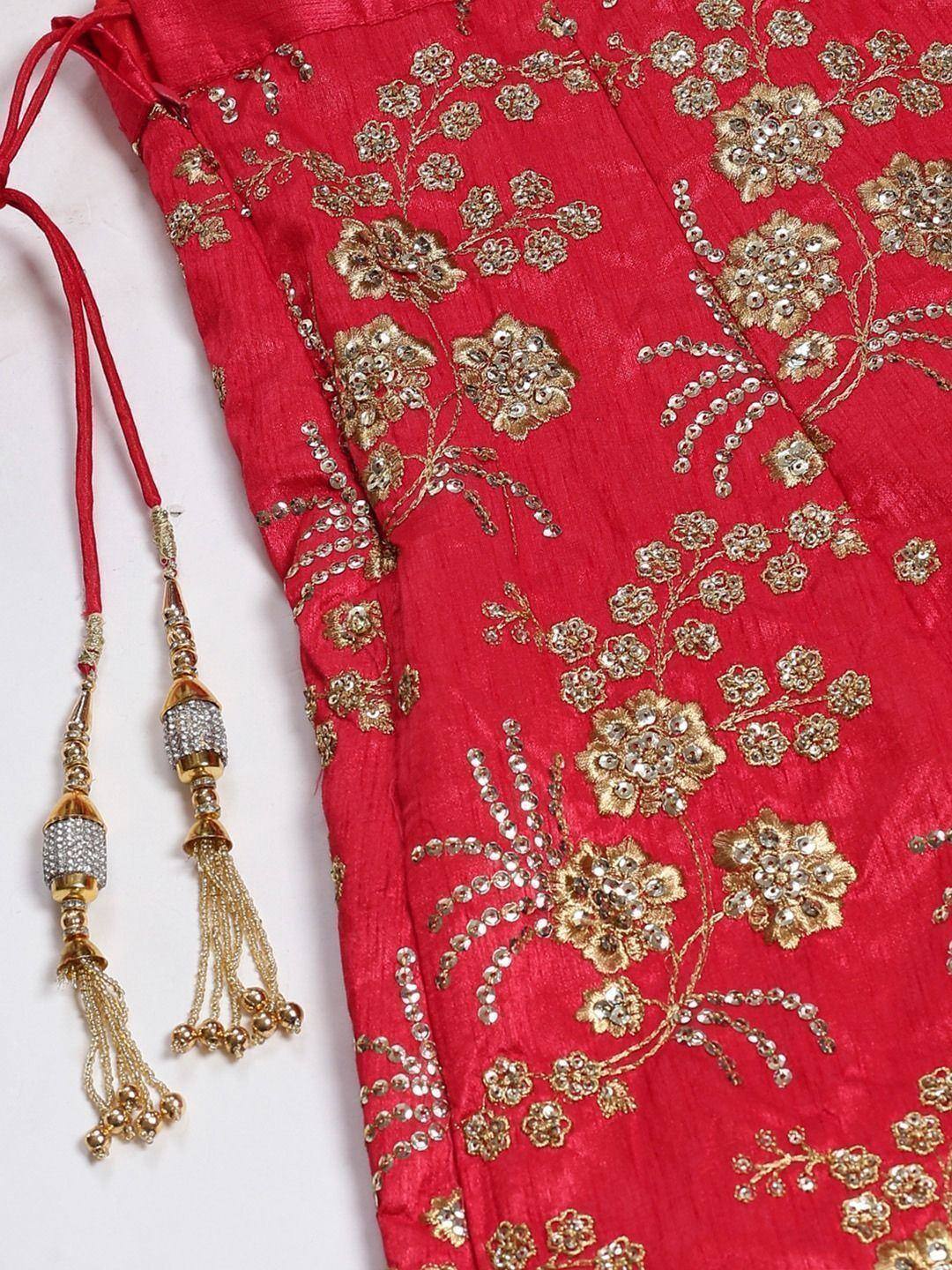 Red ethnic lehenga with gold floral embroidery and beaded tassels, perfect for Indian weddings and festive occasions.