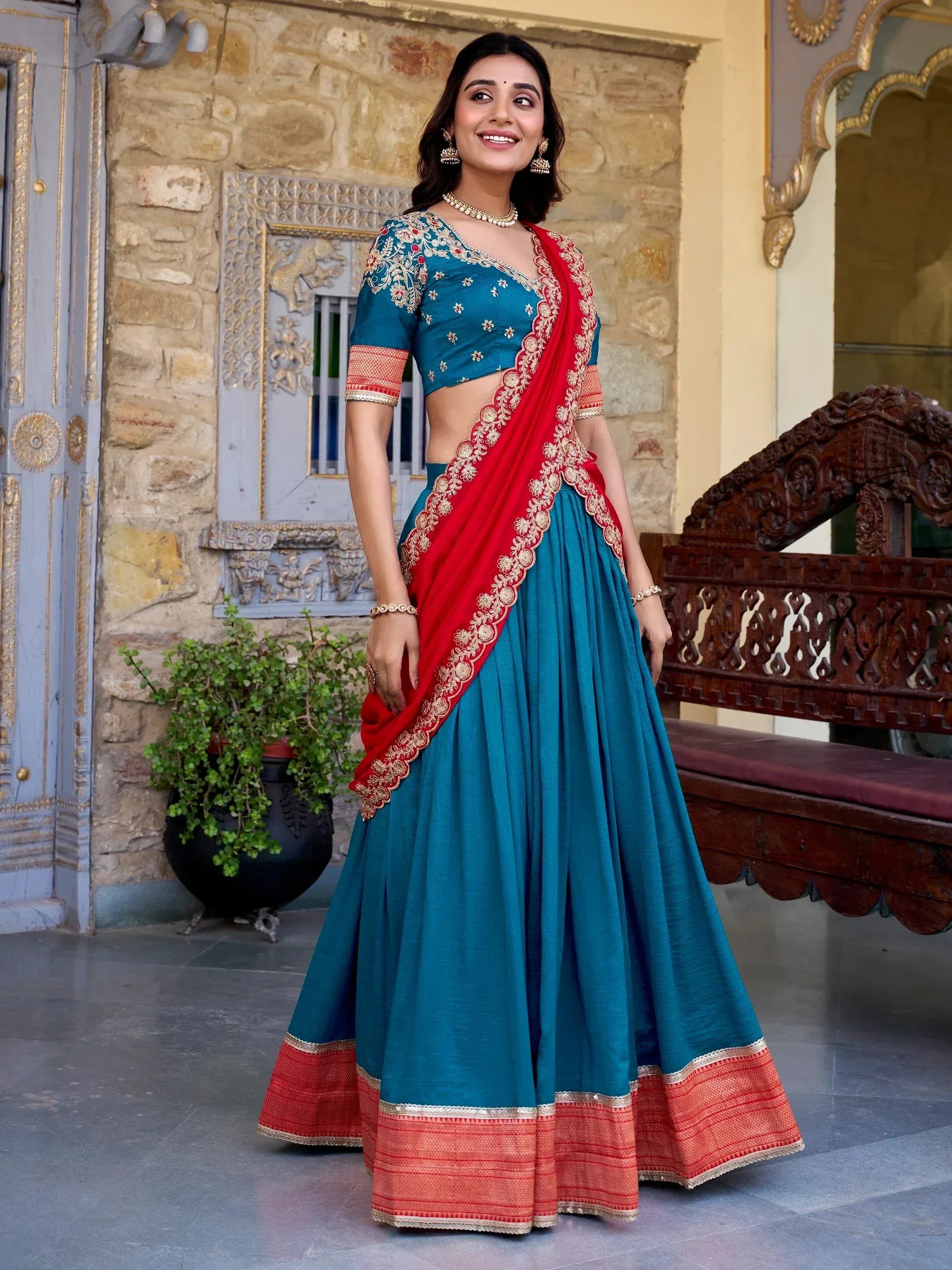 Teal and red embroidered lehenga choli with gold detailing, perfect for Indian ethnic wear occasions