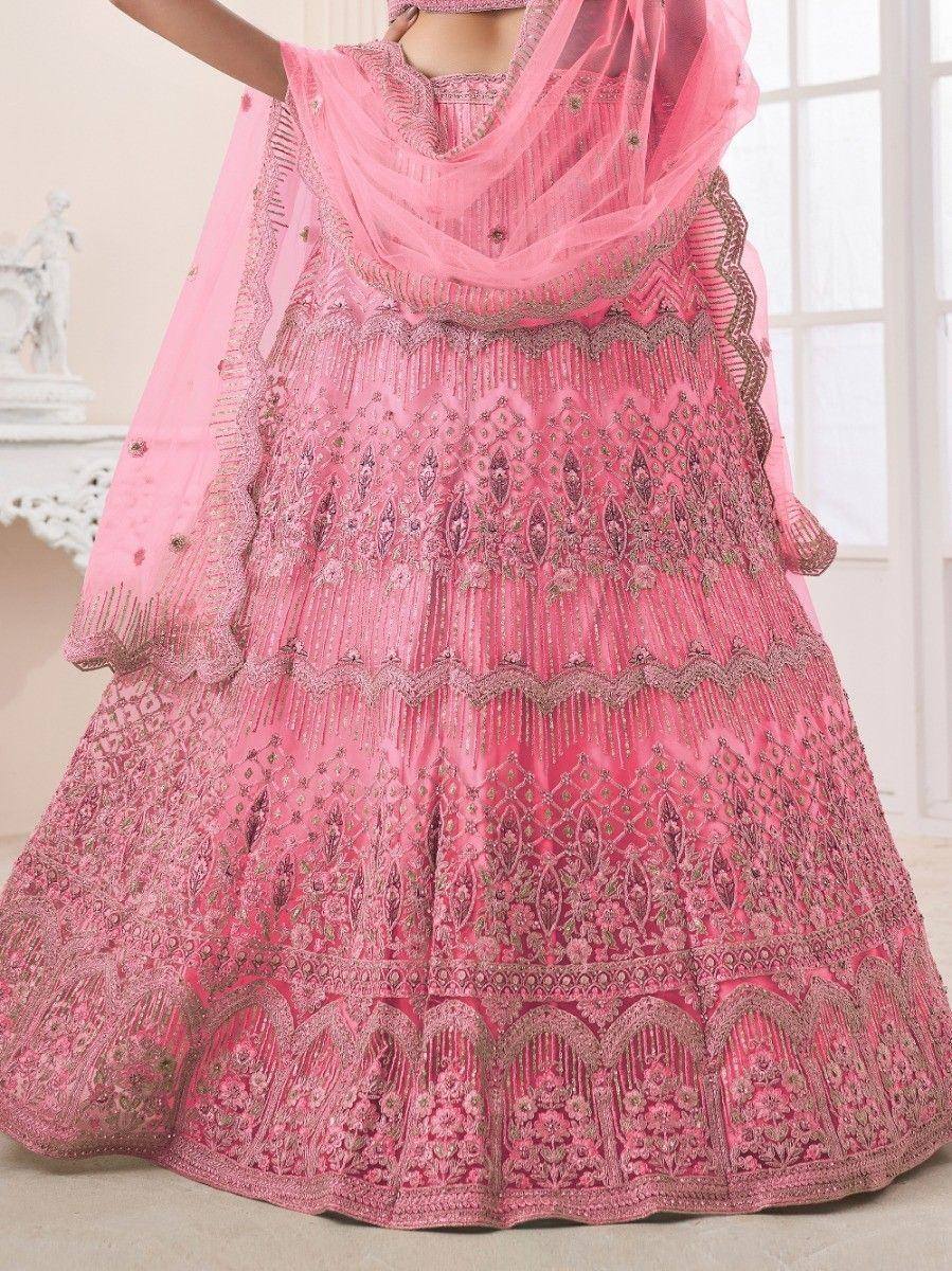 Pink designer lehenga choli with intricate embroidery and matching dupatta, perfect for weddings and festive occasions.