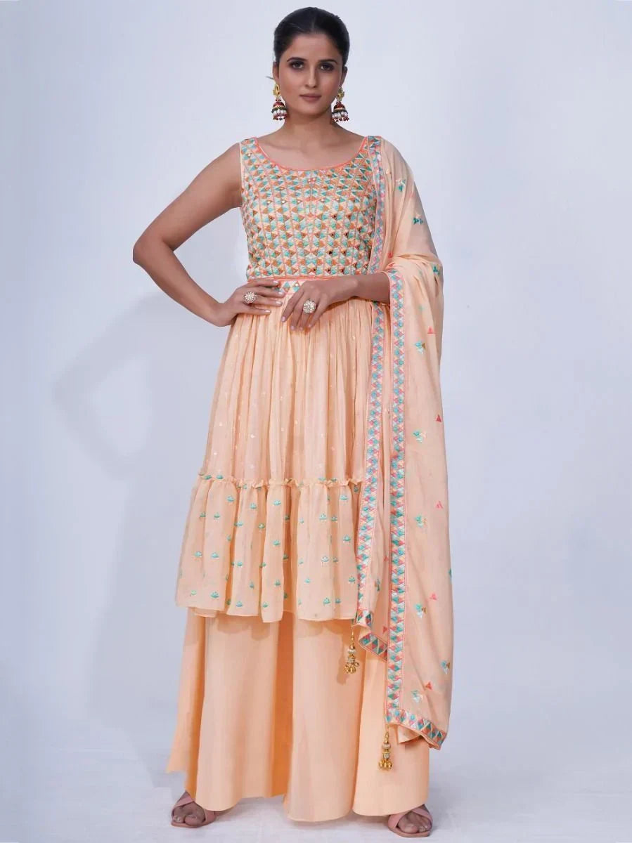 Woman wearing peach embroidered ethnic suit with palazzo pants and dupatta