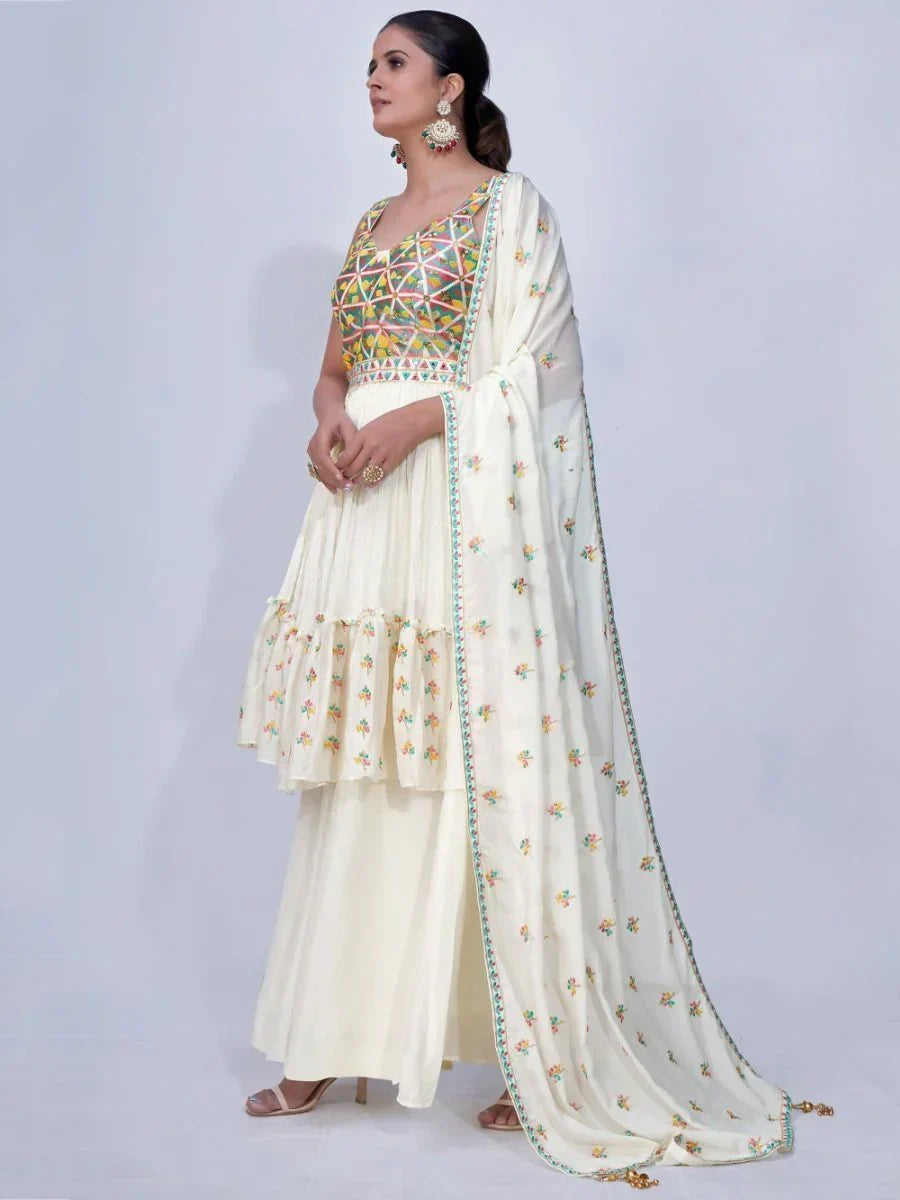 Woman wearing a cream ethnic lehenga with multicolor embroidered blouse and dupatta
