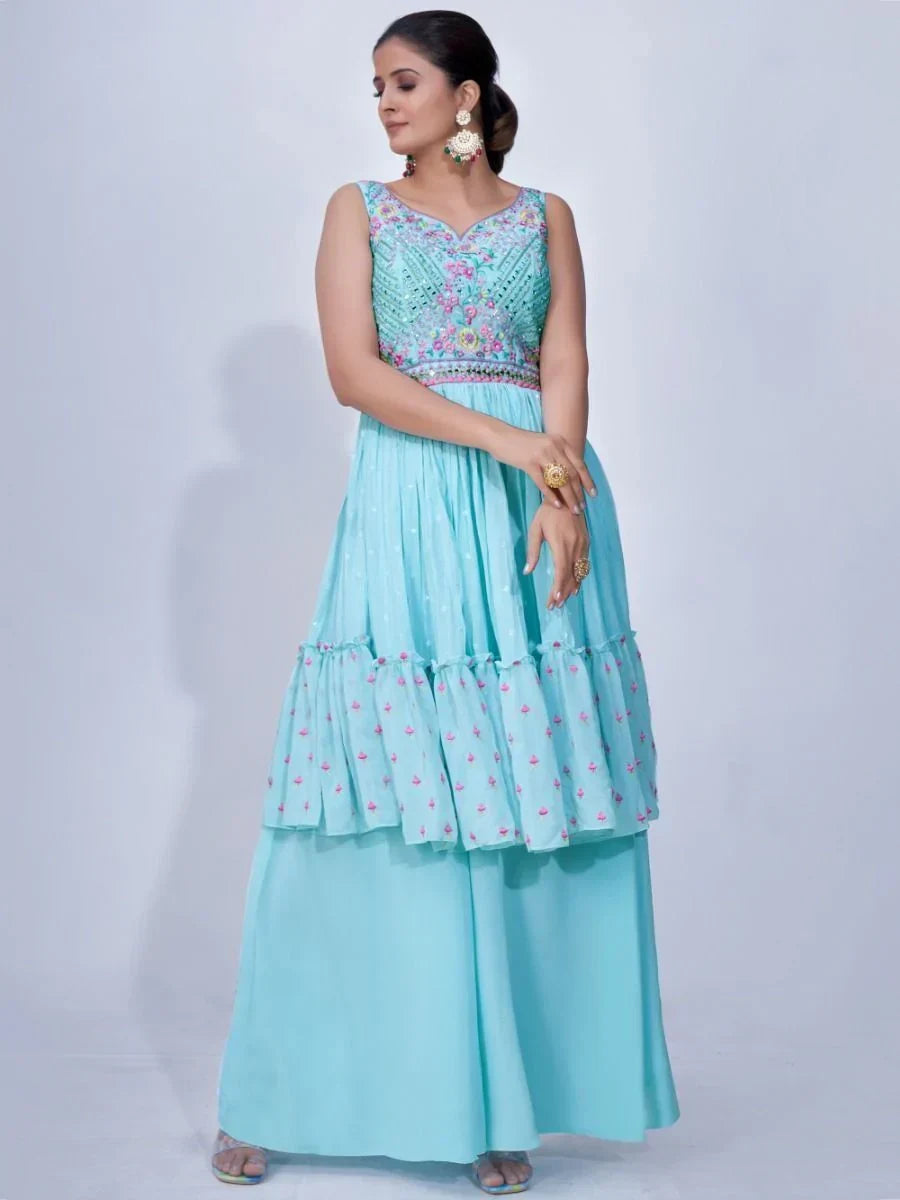 Woman wearing a light blue embroidered ethnic gown with palazzo pants and floral details