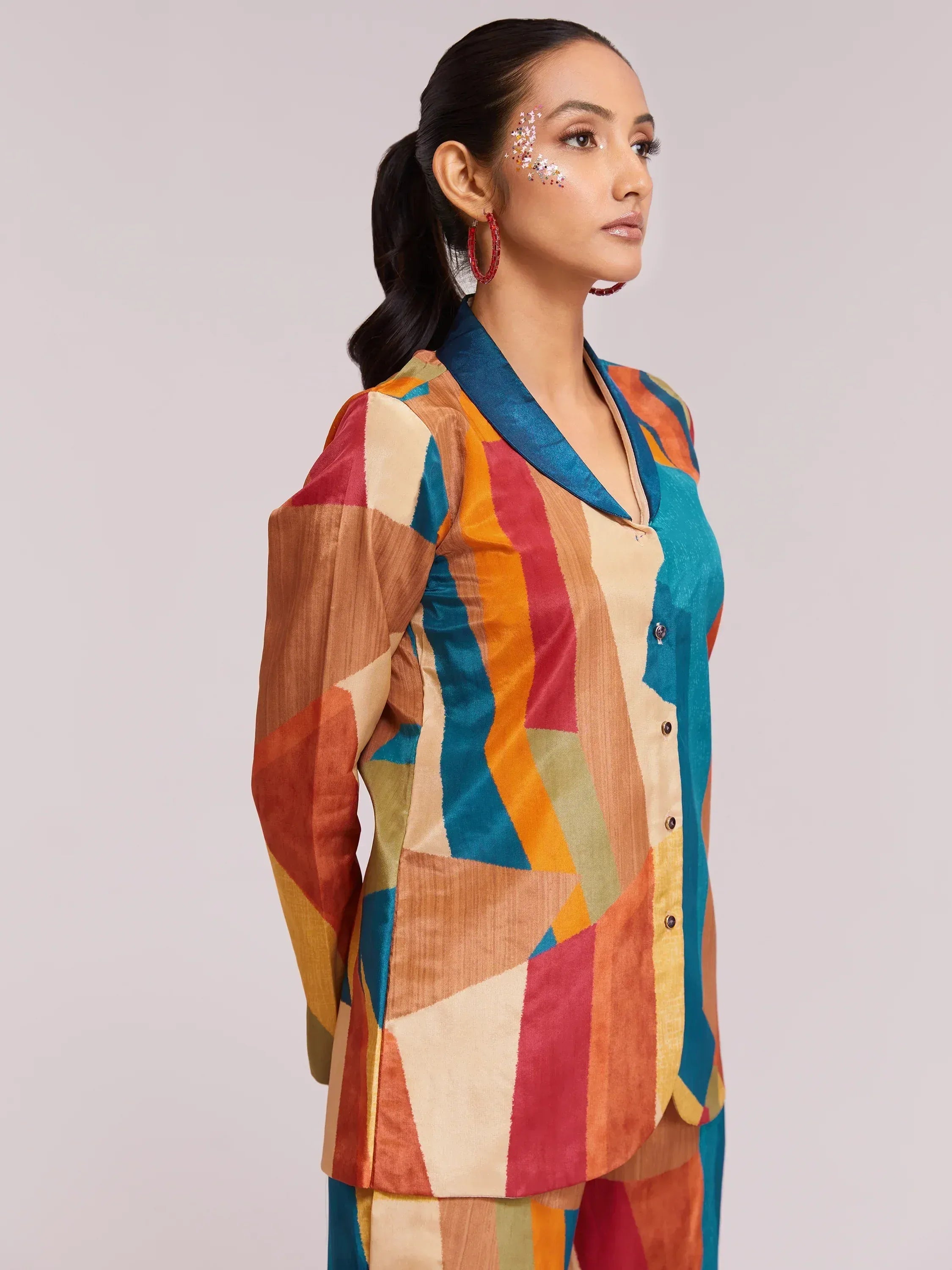 Woman in colorful geometric print ethnic kurta with blue collar, styled for festive occasions