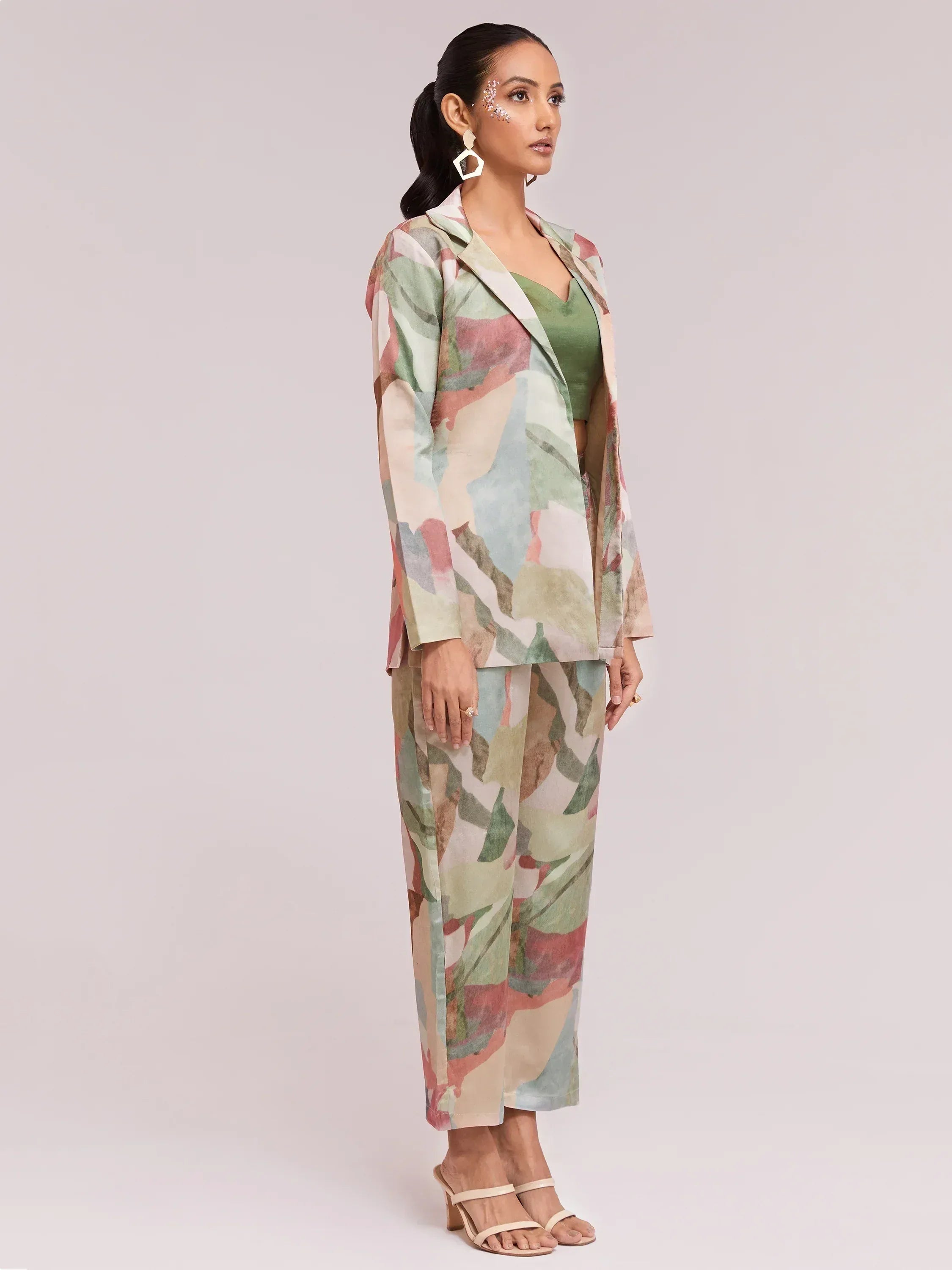 Woman in floral print ethnic suit with green top, perfect for Indian occasions and festive wear.