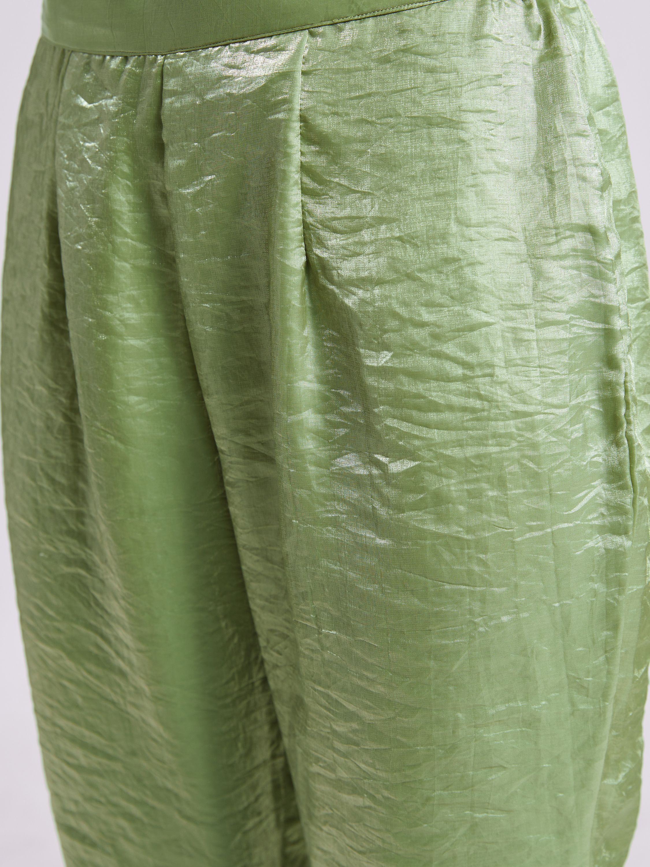 Close-up of light green silk ethnic lehenga skirt with a crinkled texture