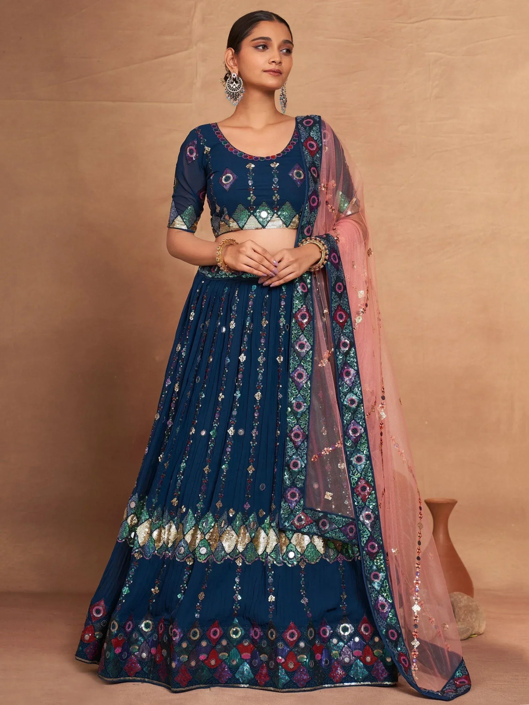 Elegant navy blue lehenga choli with intricate mirror and sequin work, paired with a pink dupatta