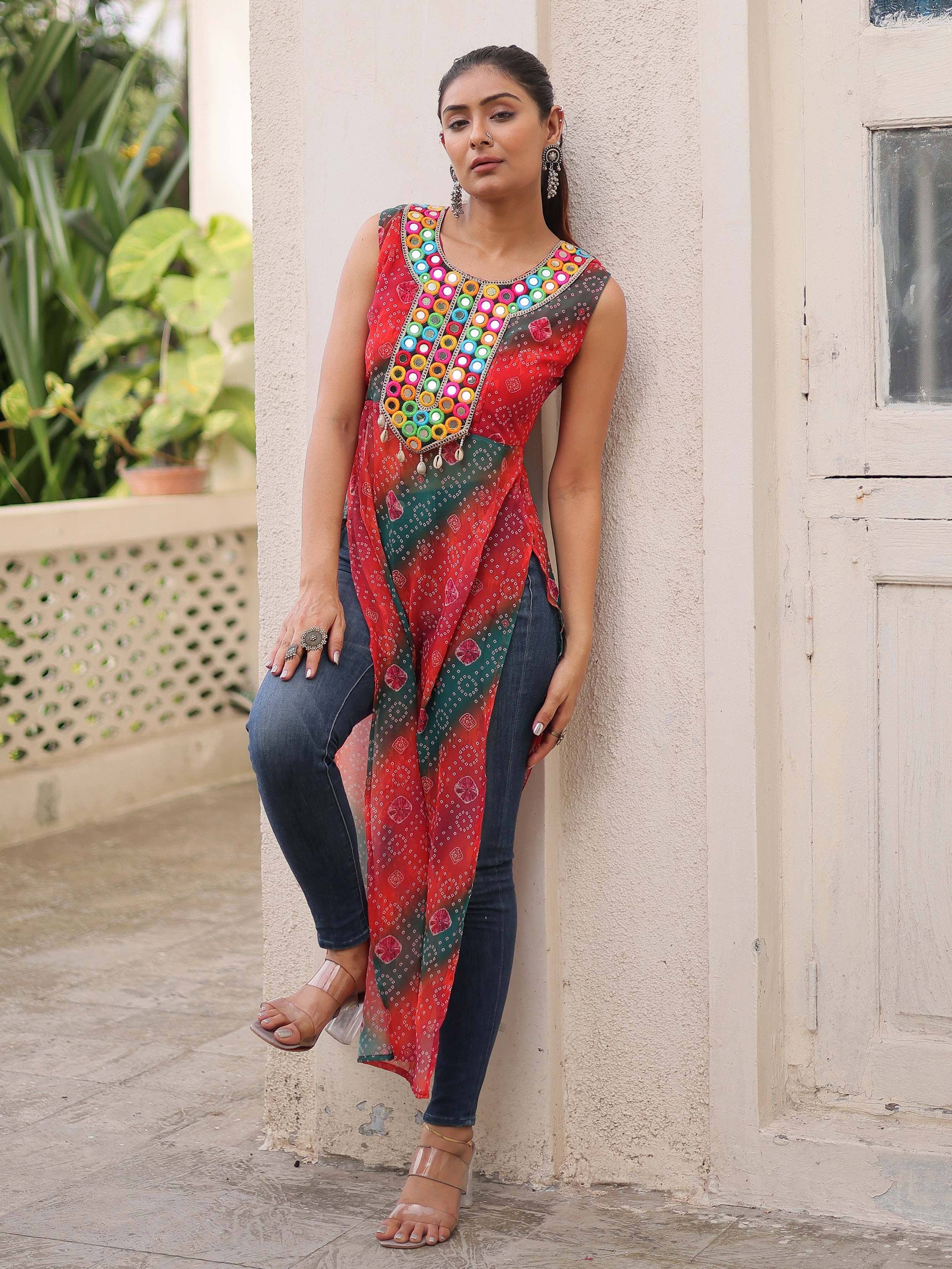 Woman in colorful mirror-work ethnic kurti with jeans, perfect for Indian festive wear