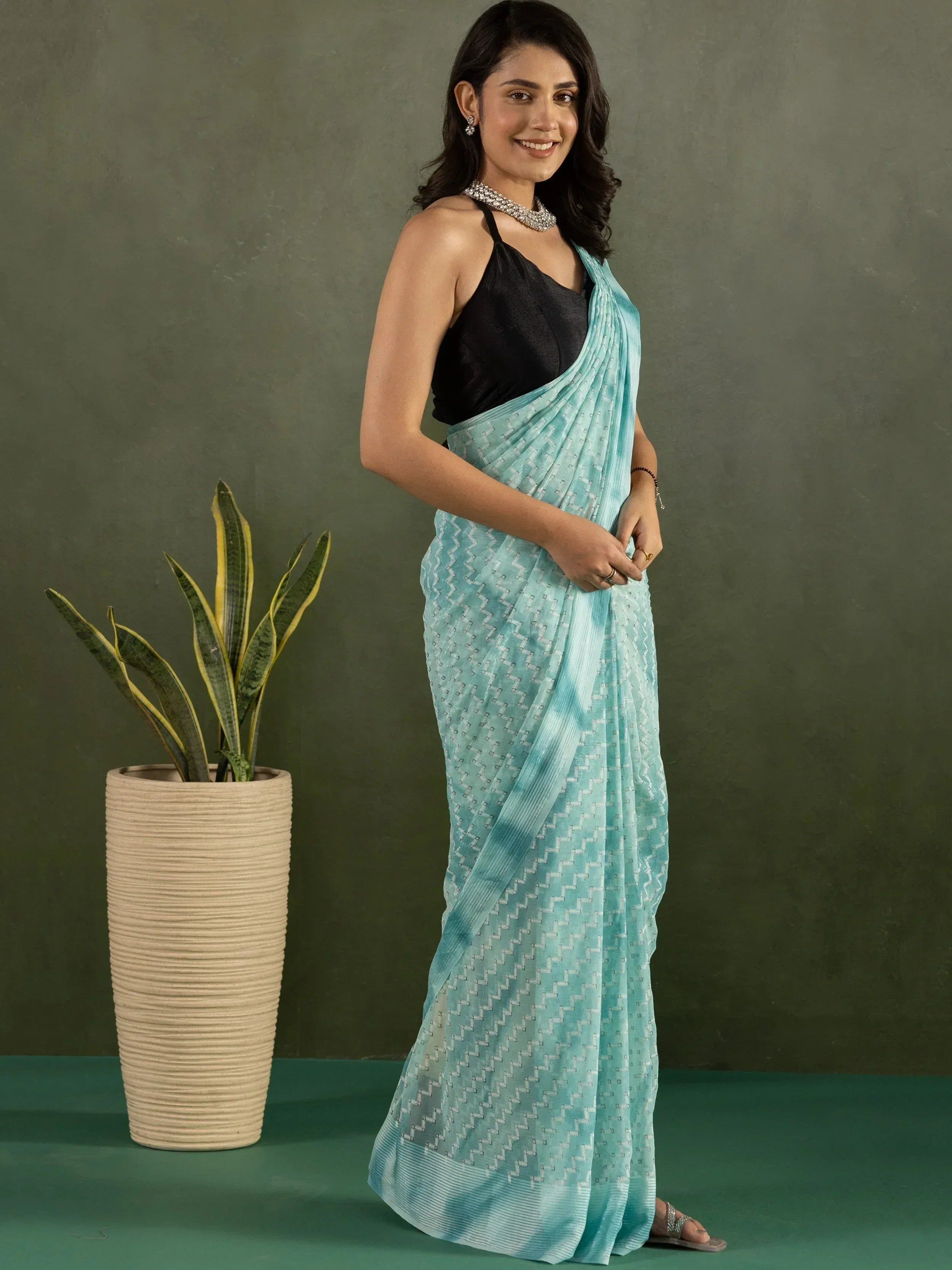 Woman in light blue printed saree with black blouse, ethnic wear for women
