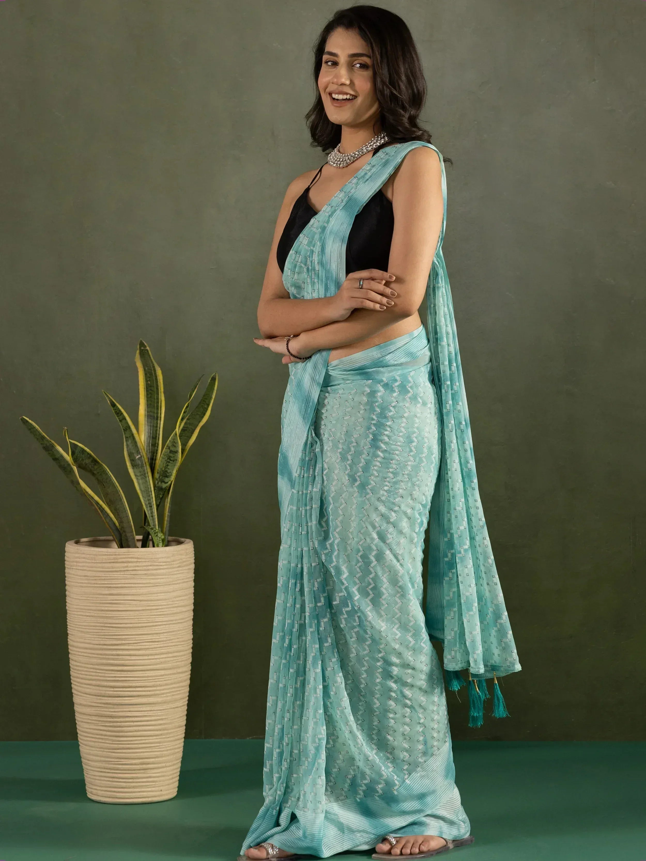 Woman in light blue printed saree with black blouse, ethnic wear for Indian occasions