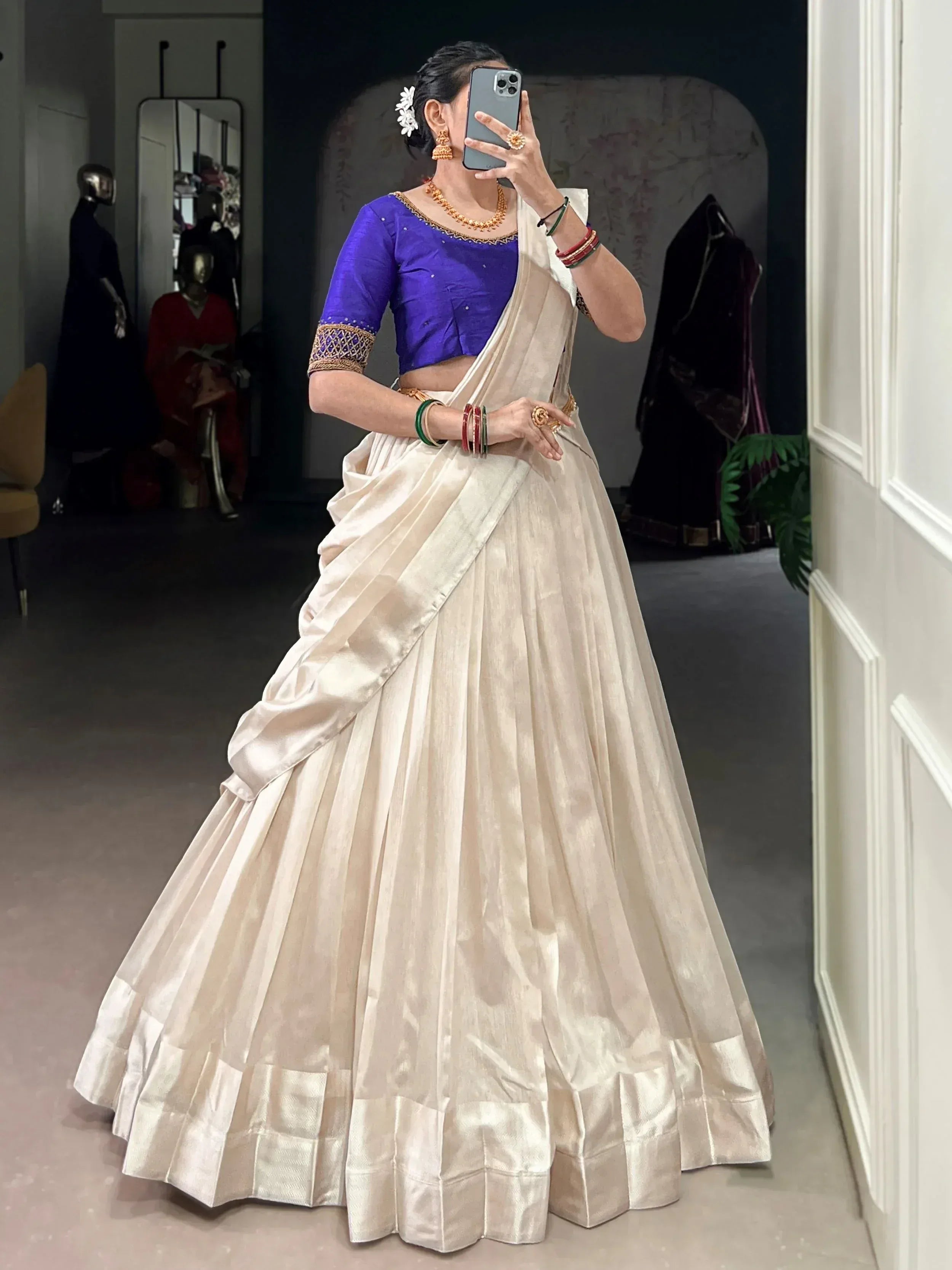 Cream silk lehenga with purple blouse, gold embroidery, and traditional Indian jewelry for ethnic wear