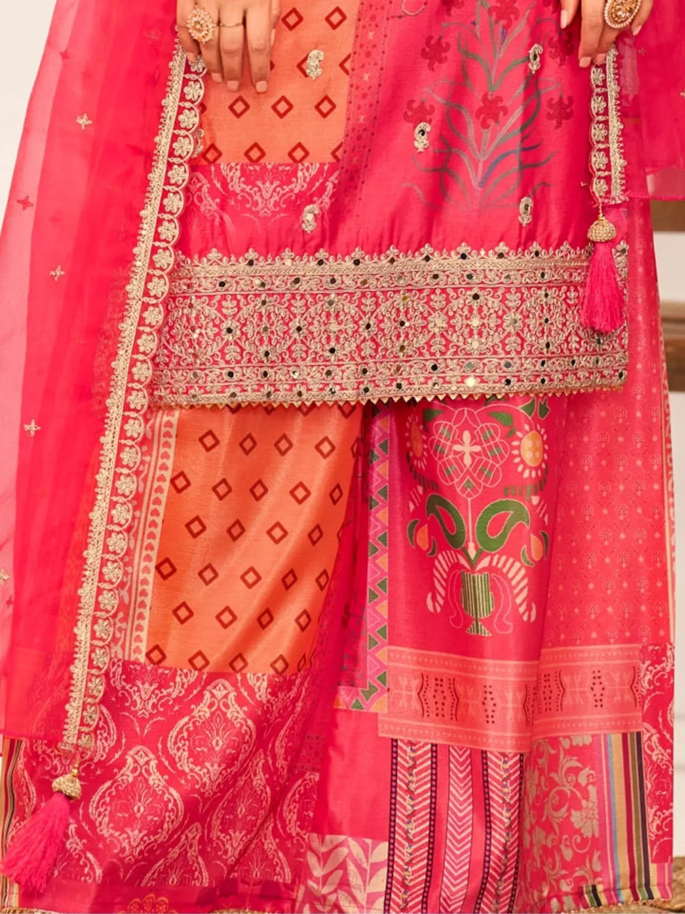 Pink and orange embroidered ethnic wear with intricate gold detailing and floral patterns