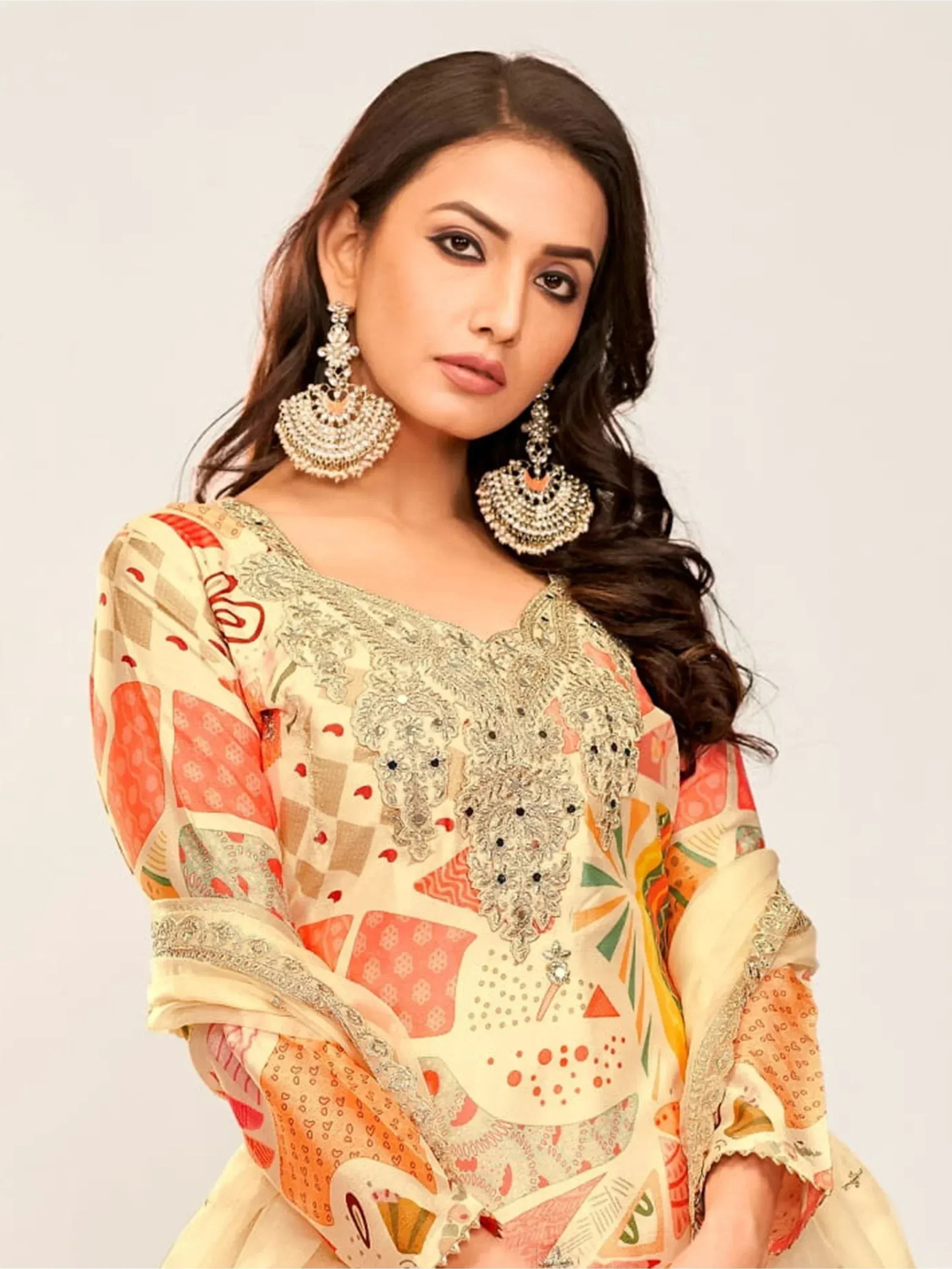 Woman in printed ethnic kurta with embroidery and jhumka earrings, Indian designer wear