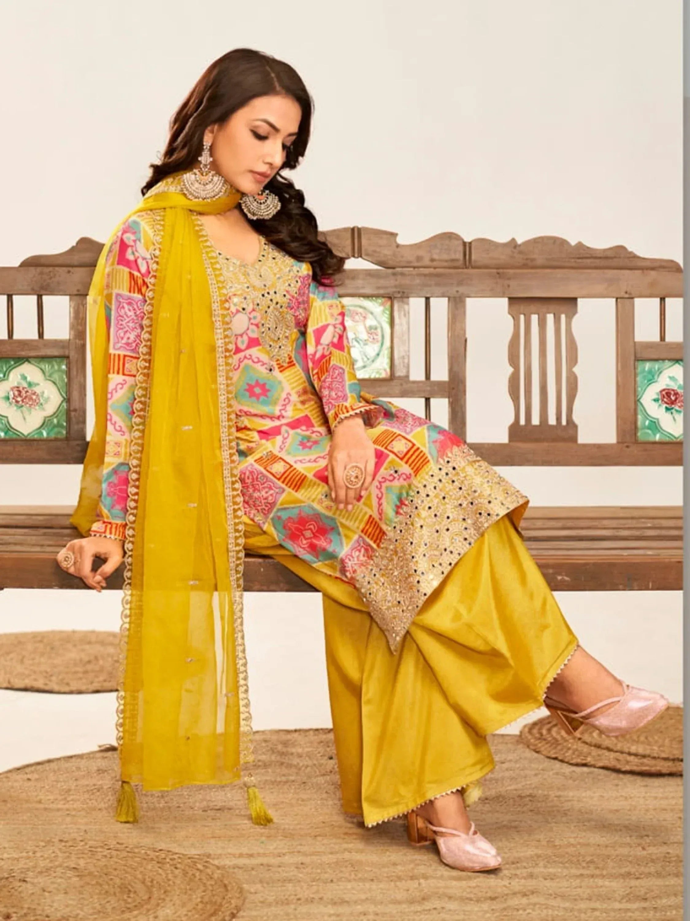 Woman in vibrant yellow printed salwar kameez with embroidered dupatta, perfect for Indian ethnic wear occasions.