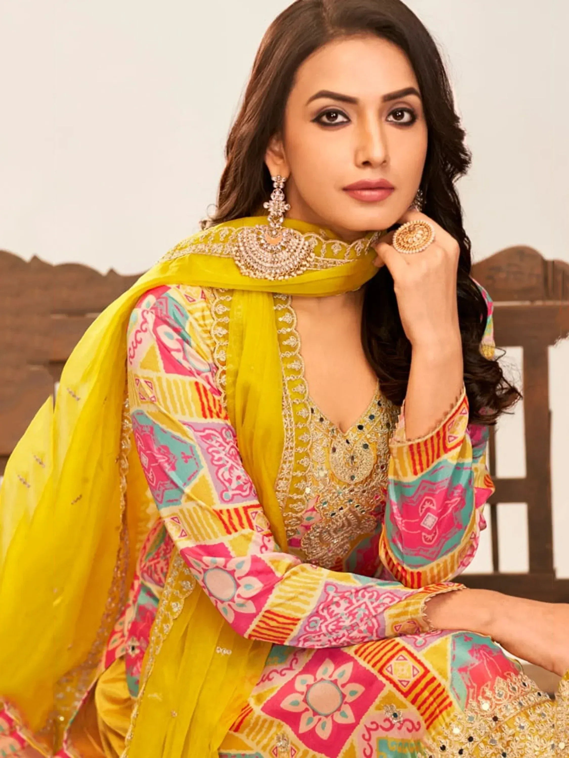 Vibrant yellow and pink printed ethnic suit with embroidery, perfect for festive occasions. Stylish salwar kameez with dupatta.