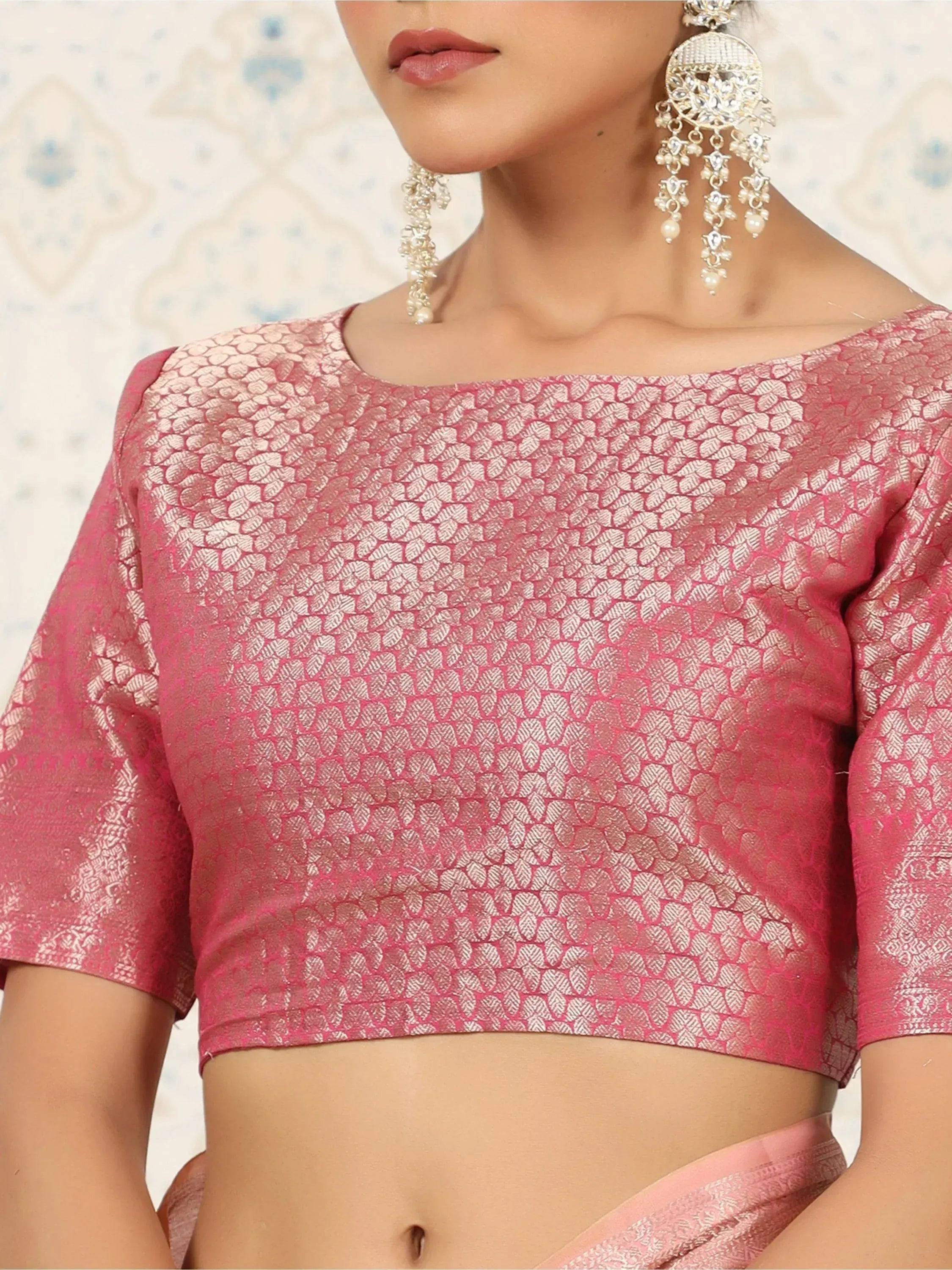Pink ethnic blouse with leaf pattern, paired with jhumka earrings for Indian wear