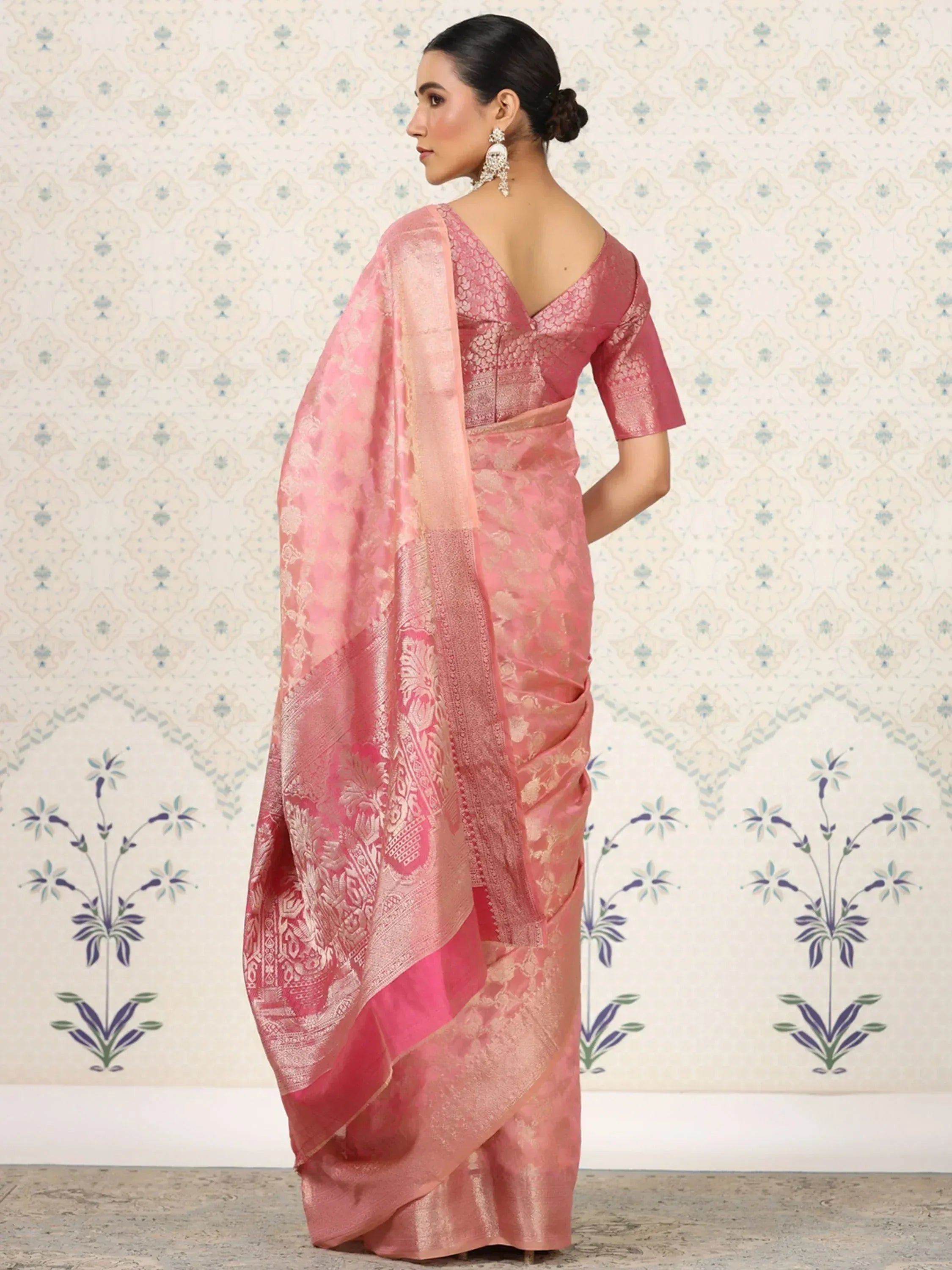 Pink designer saree with gold floral motifs, perfect for ethnic wear and festive occasions.