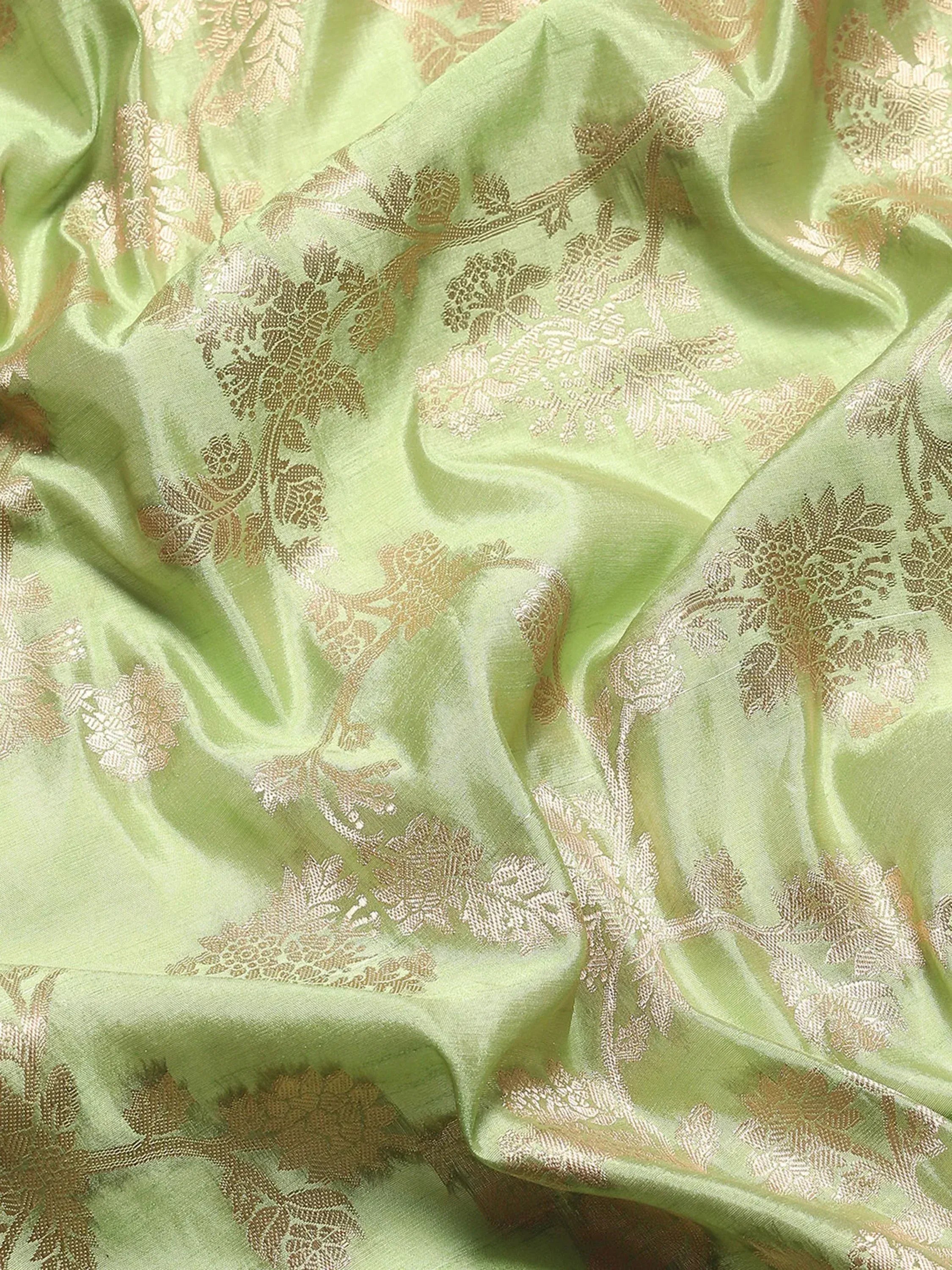 Light green ethnic fabric with gold floral embroidery, ideal for designer lehengas and sarees.