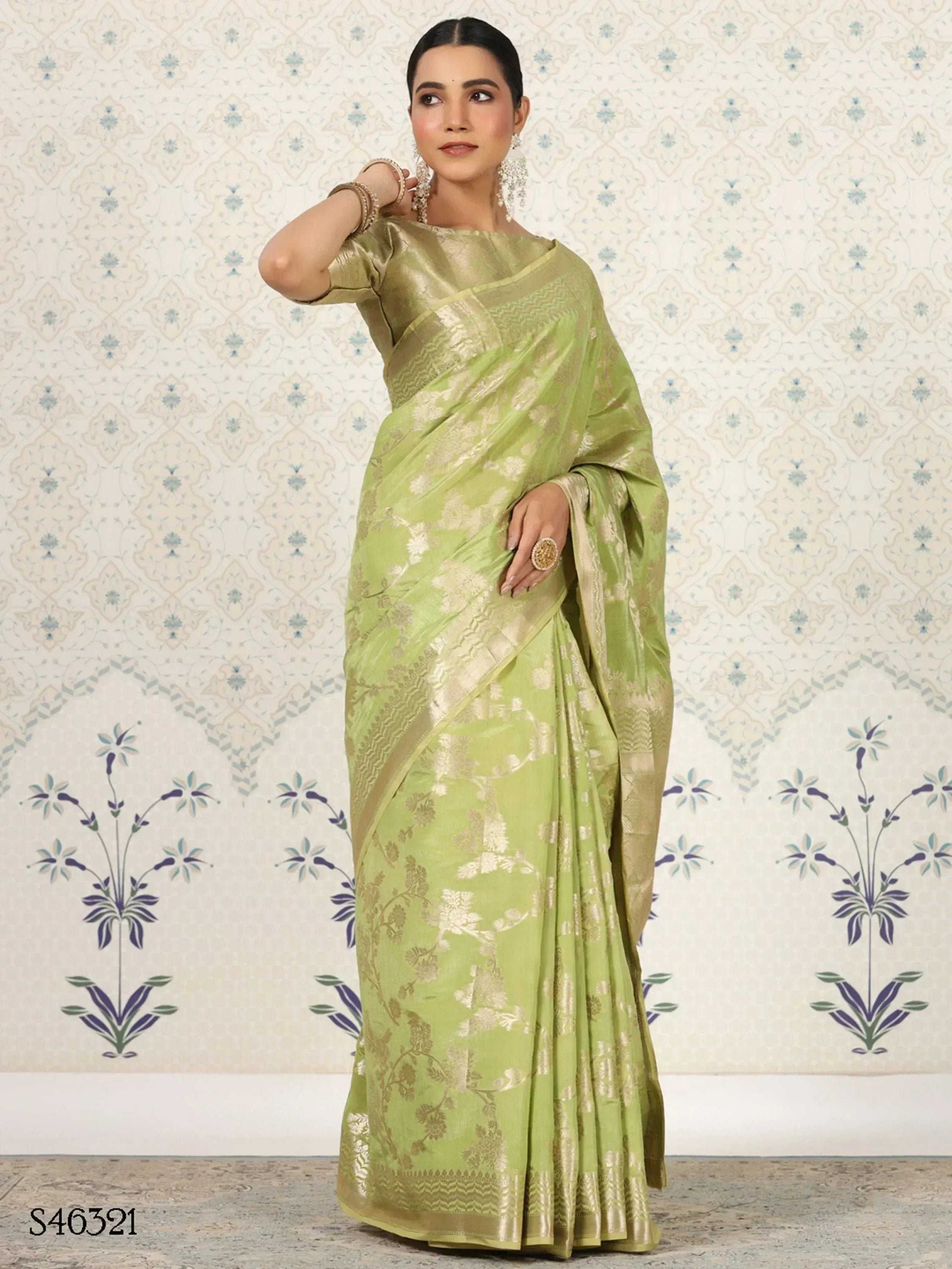 Elegant green designer saree with gold floral motifs, perfect for ethnic occasions.