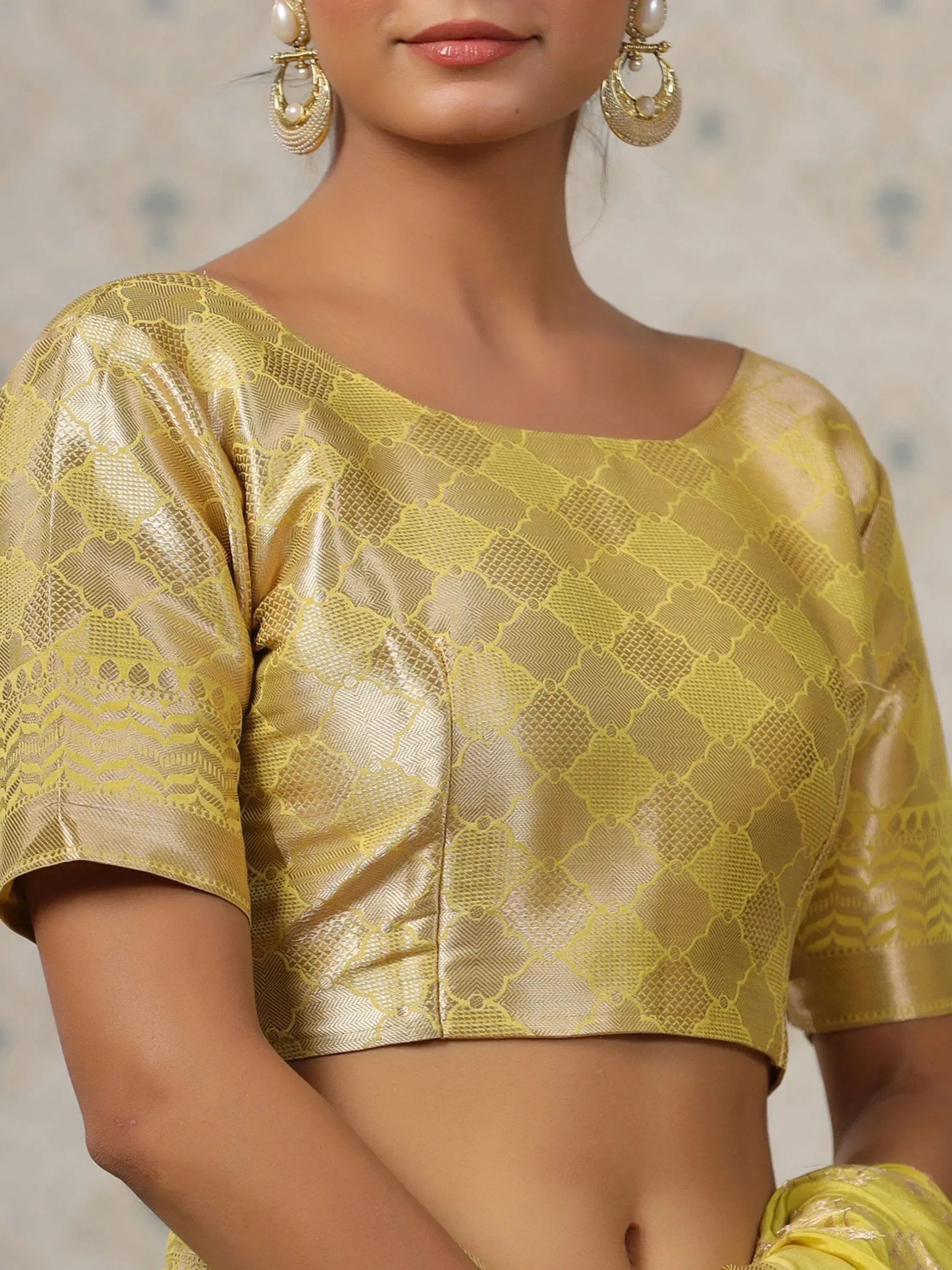 Golden designer blouse with intricate patterns, perfect for ethnic wear