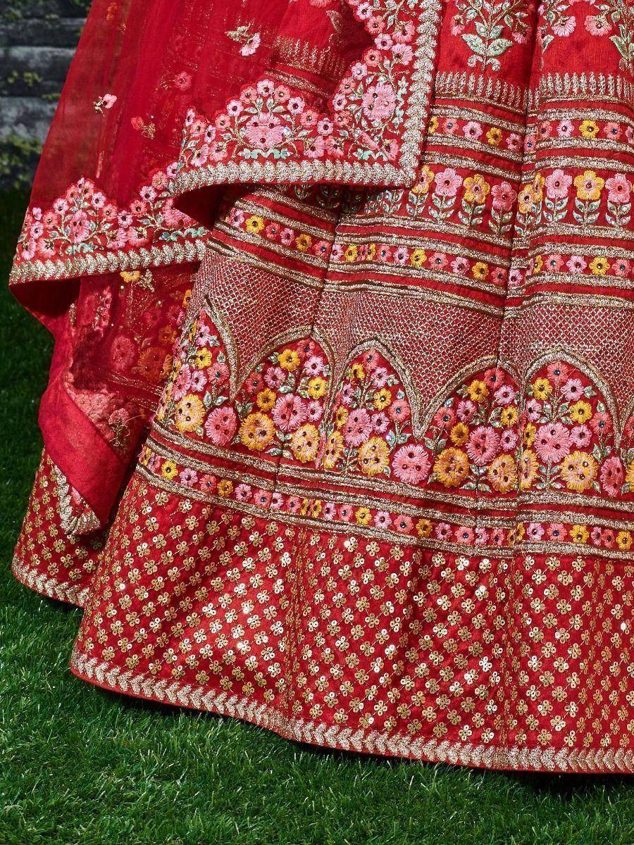 Red embroidered lehenga with floral patterns and gold detailing, perfect for Indian ethnic wear