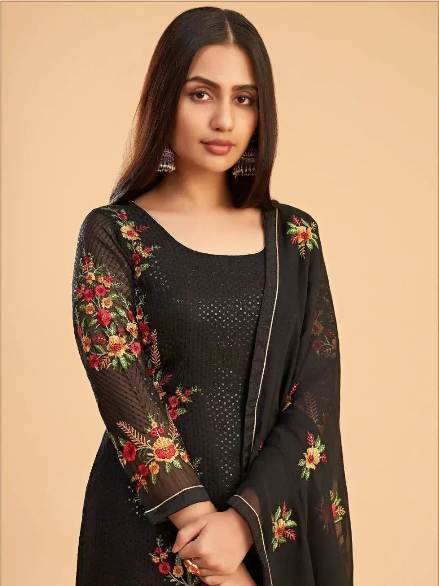 Woman in black embroidered salwar kameez with floral designs, ethnic wear fashion