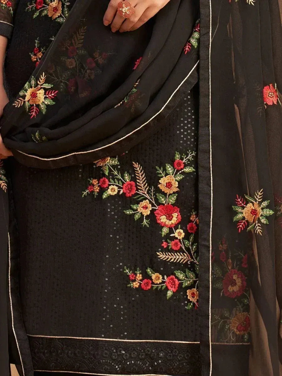 Black salwar kameez with red and gold floral embroidery, sheer dupatta