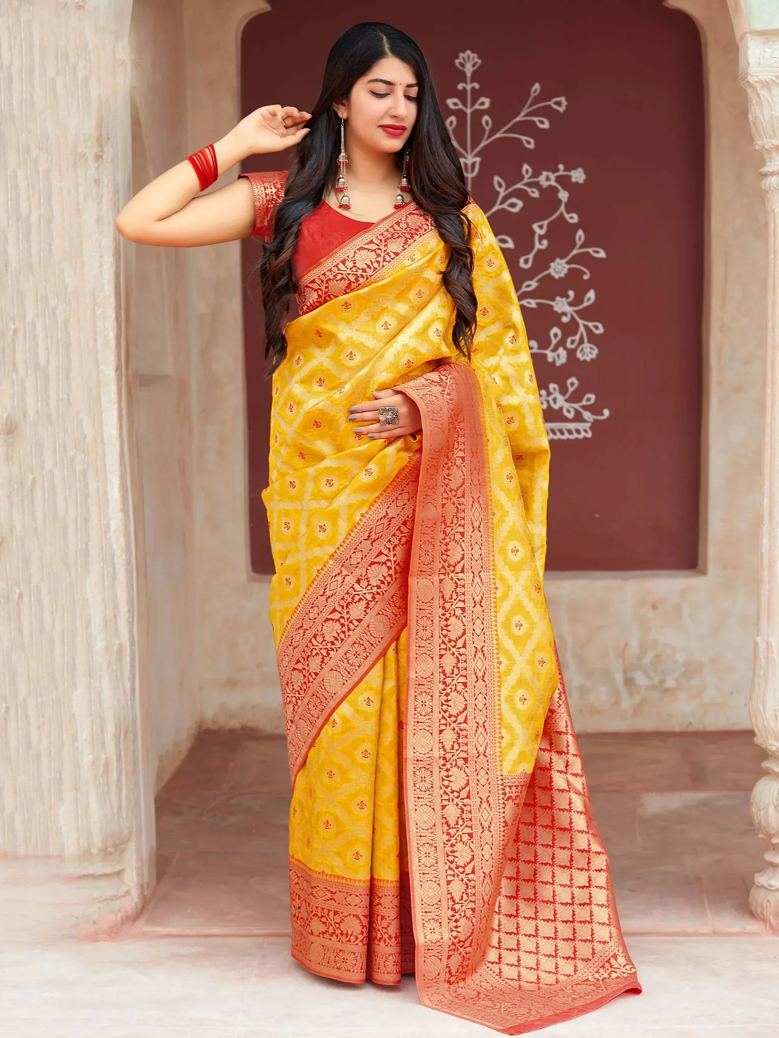 Yellow and red ethnic saree with intricate patterns, perfect for Indian occasions and festivals.