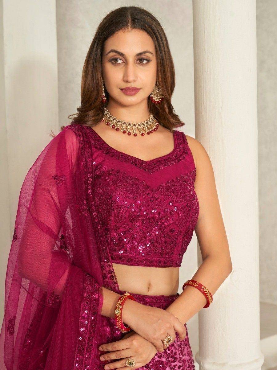 Elegant maroon sequin lehenga choli with sheer dupatta, perfect for Indian weddings and festive occasions.