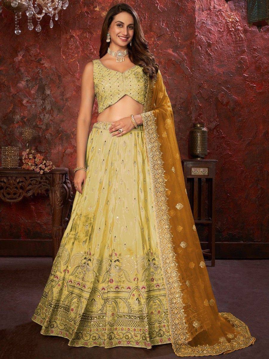 Elegant yellow designer lehenga choli with intricate embroidery and matching dupatta for Indian ethnic wear