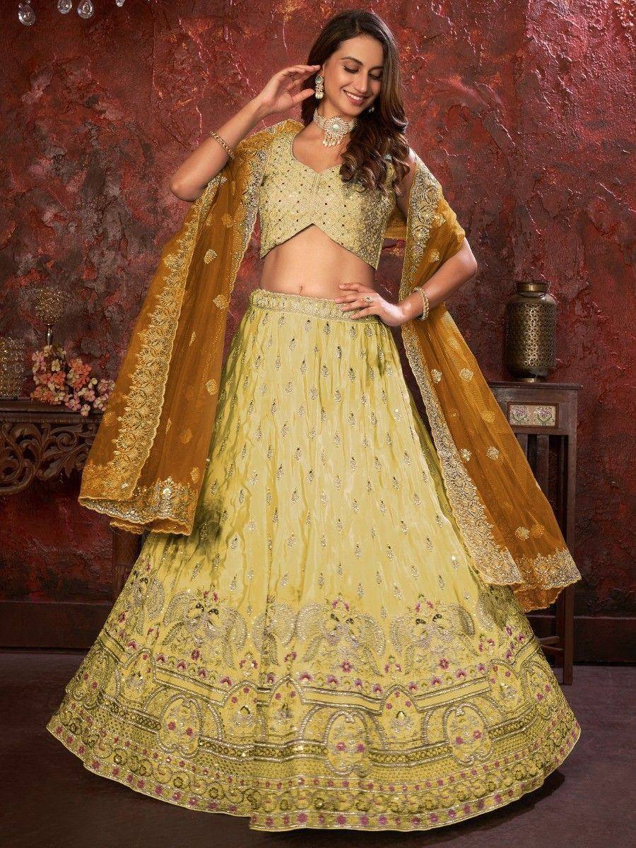 Elegant yellow designer lehenga choli with intricate embroidery and matching dupatta for Indian ethnic wear