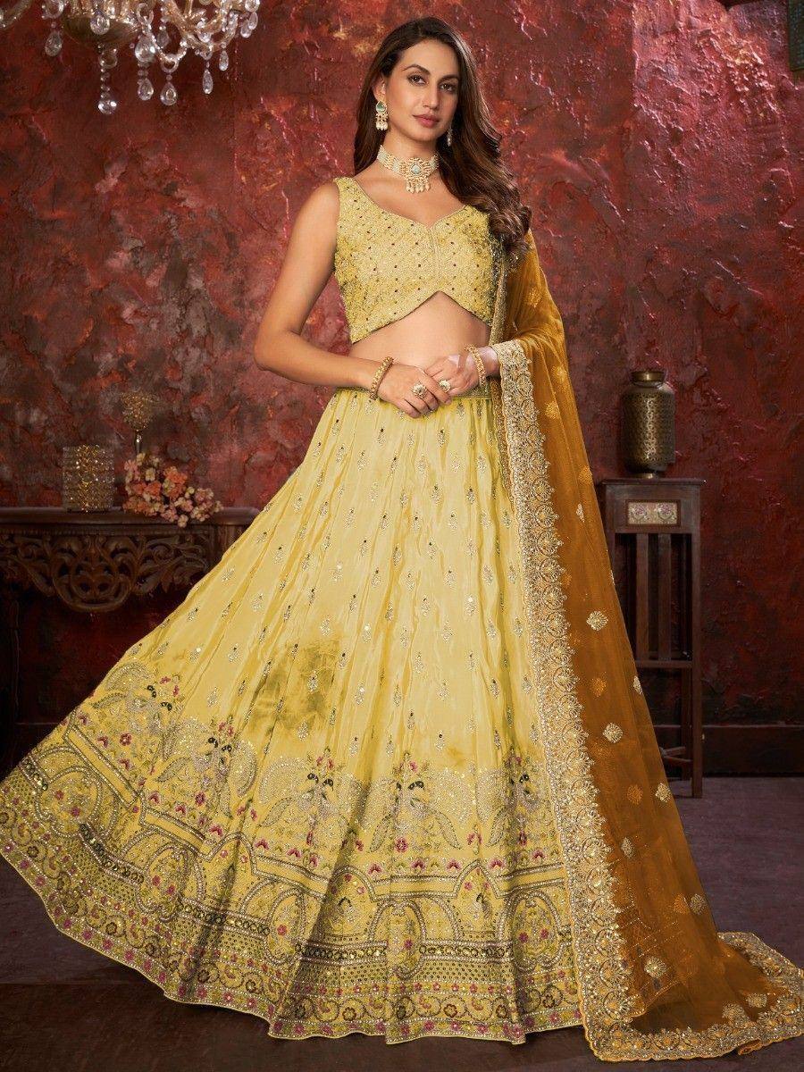 Yellow designer lehenga choli with intricate embroidery and matching dupatta, perfect for Indian ethnic occasions