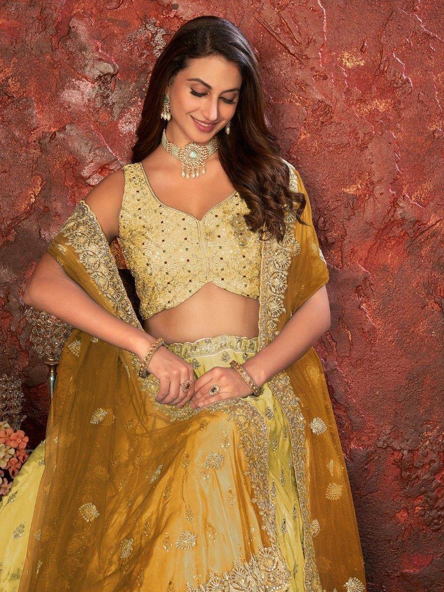Elegant gold embroidered lehenga choli with matching dupatta, perfect for Indian weddings and festive occasions.