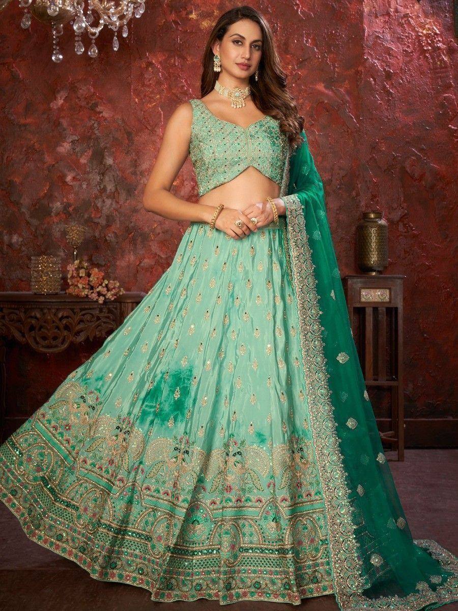 Mint green designer lehenga choli with gold embroidery and matching dupatta, perfect for Indian weddings and festivals.