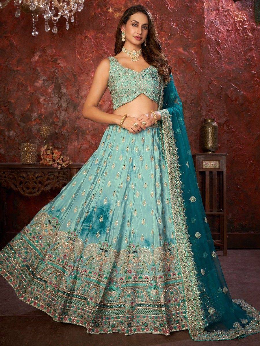 Teal designer lehenga choli with intricate gold embroidery and peacock motifs, perfect for Indian ethnic wear occasions