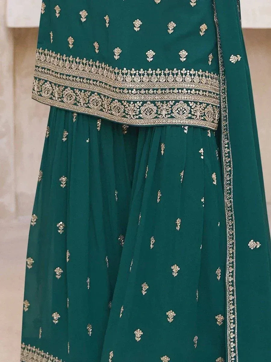 Emerald green ethnic sharara suit with gold embroidery, perfect for Indian weddings and festive occasions.