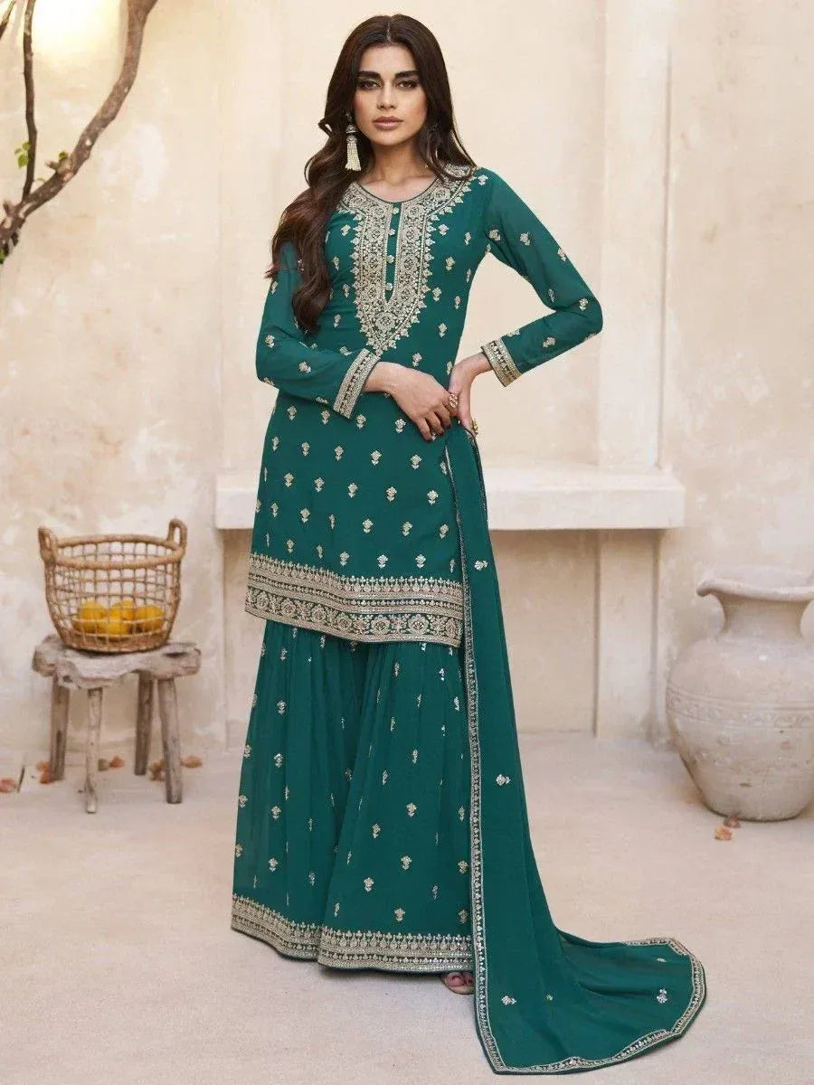 Emerald green embroidered salwar kameez with gold detailing, perfect for ethnic occasions