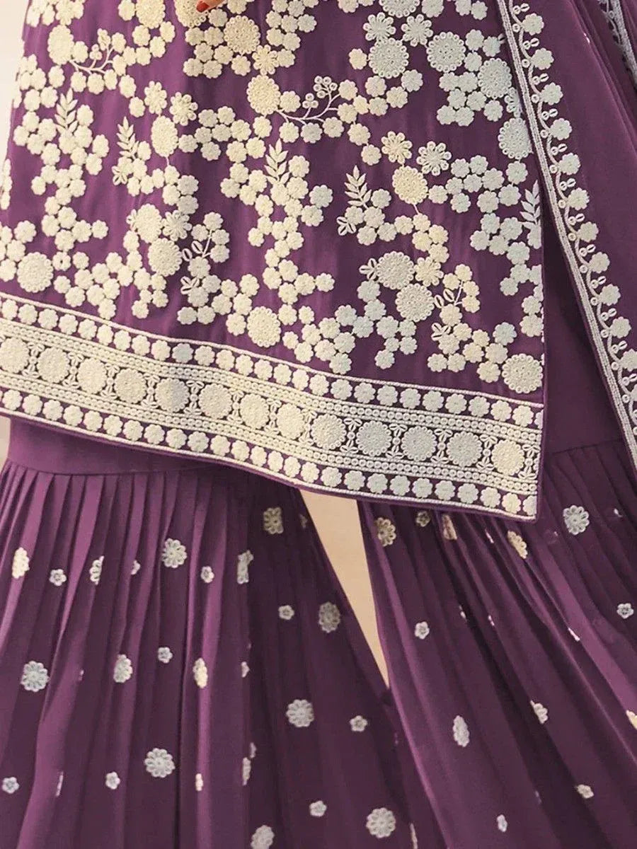 Purple ethnic gown with white floral embroidery and pleated skirt, perfect for Indian occasions