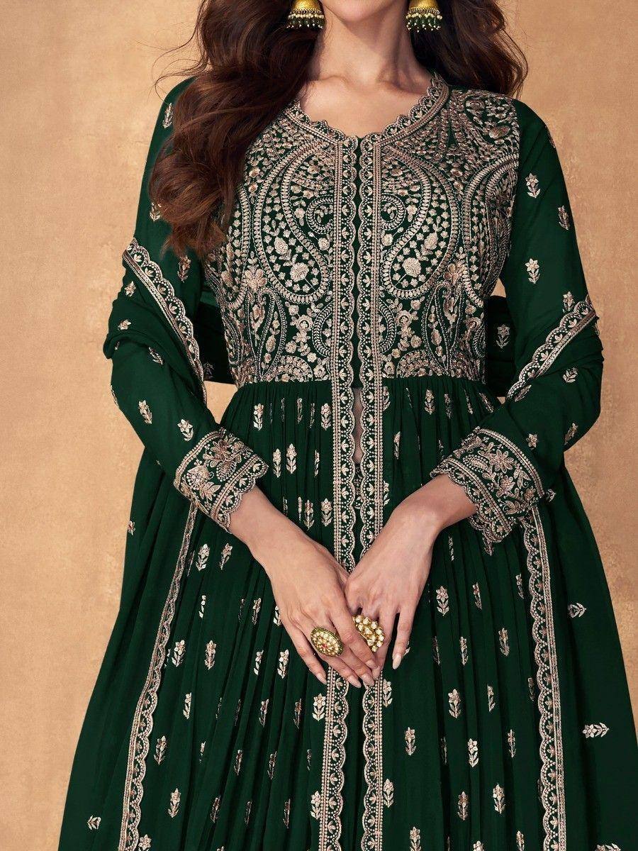 Woman wearing a green embroidered ethnic gown with gold jewelry, detailed traditional design