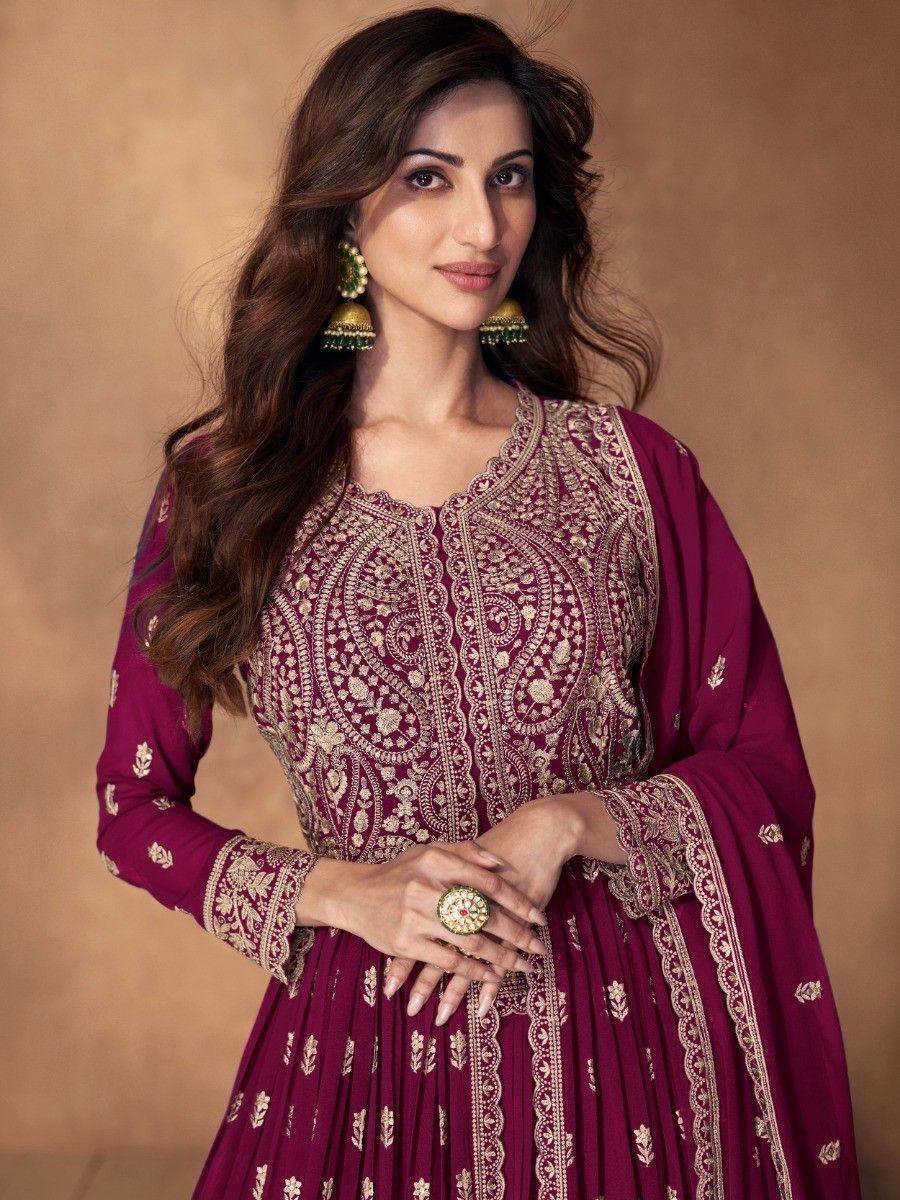 Maroon embroidered ethnic gown with gold detailing, perfect for Indian festive occasions and weddings.
