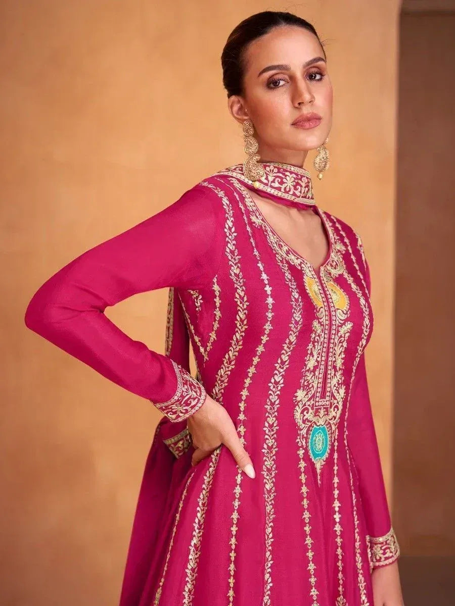 Pink embroidered ethnic gown with gold detailing and choker neck, perfect for Indian festive occasions