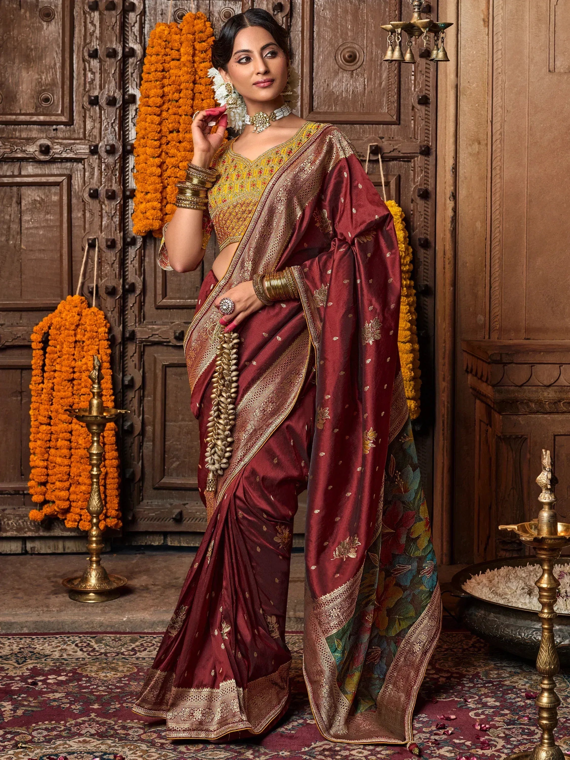 Woman in maroon silk saree with gold embroidery, yellow blouse, floral border, traditional Indian ethnic wear