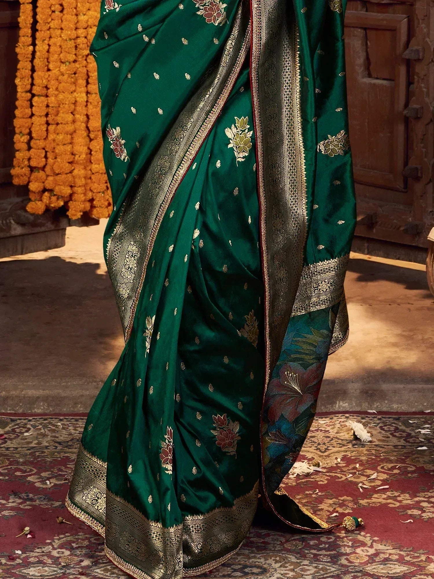 Emerald green silk saree with gold floral embroidery and woven border, perfect for Indian ethnic occasions.